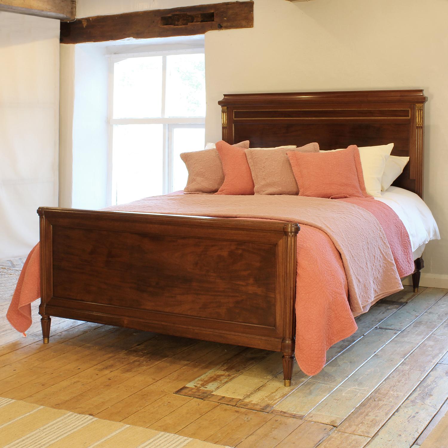 An elegant and wide French antique bed on original side runners with burr wood panels, fluted front posts and brass ormolu decoration, circa 1920.

This bed accepts a European King Size 160cm x 200cm (5'3 x 6'6) base and mattress set, and it can