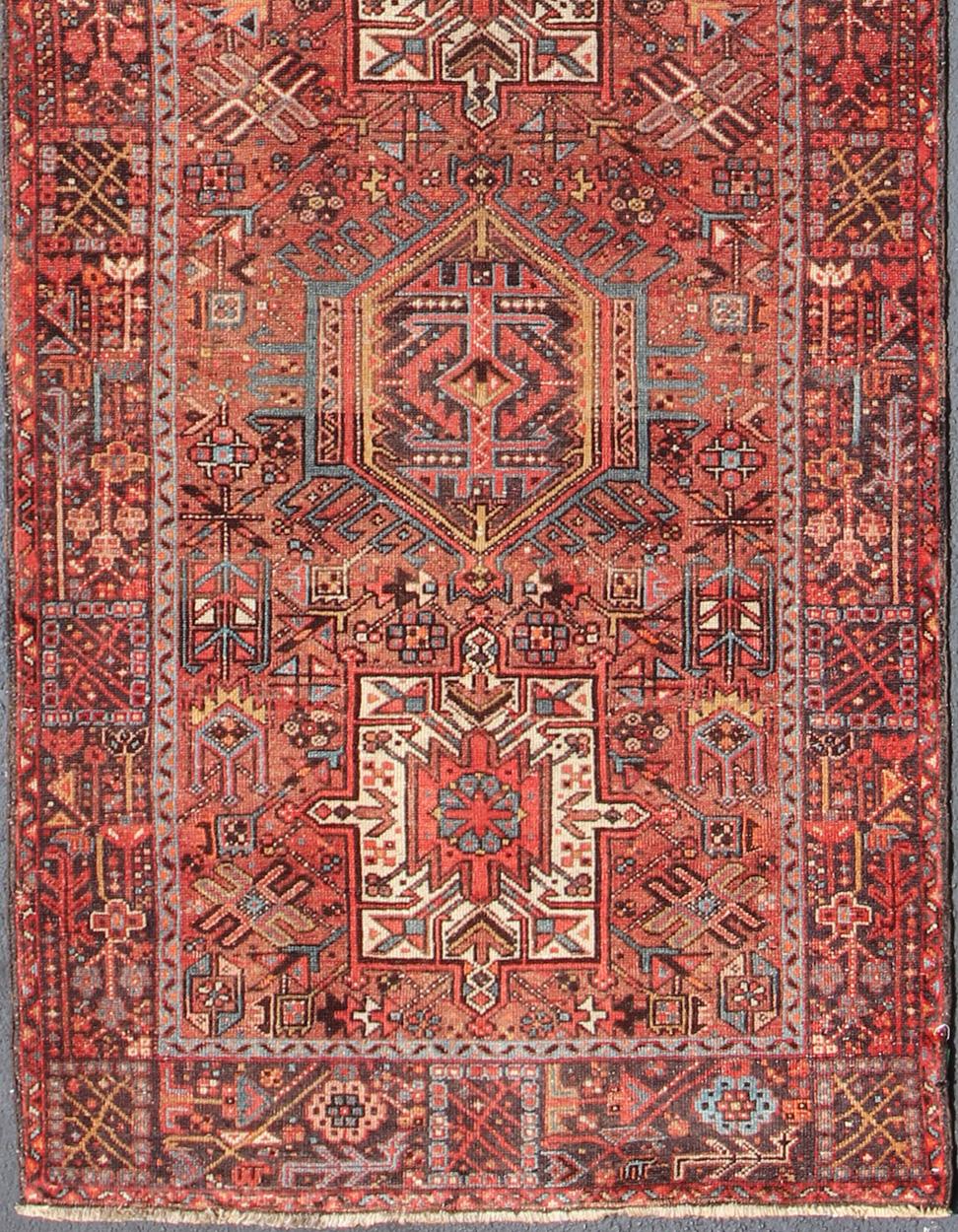 Geometric Medallion design multicolored vintage Persian Karadjeh runner, rug KB-H-604-16, country of origin / type: Iran / Karadjeh, circa 1940.

This, handwoven vintage Persian Karadjeh wide runner features a soft red-colored field imbued with a