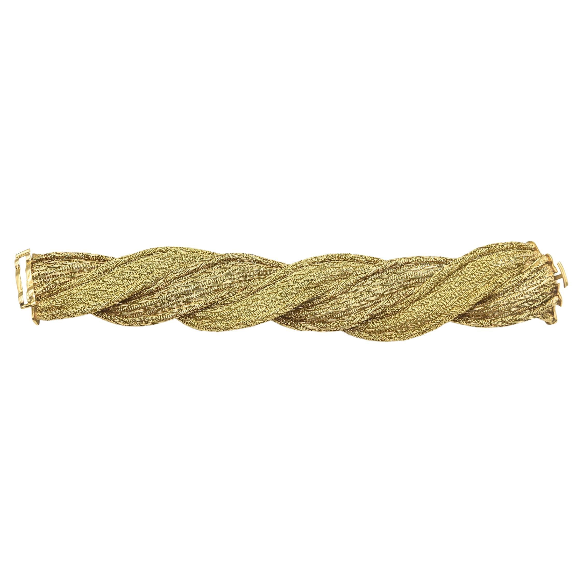 Finely handmade wide woven 18k yellow gold bracelet featuring 2 different types of weave to give it greater dimension.  It is a WOW that feels great on the arm.  It measures approximately 1.25