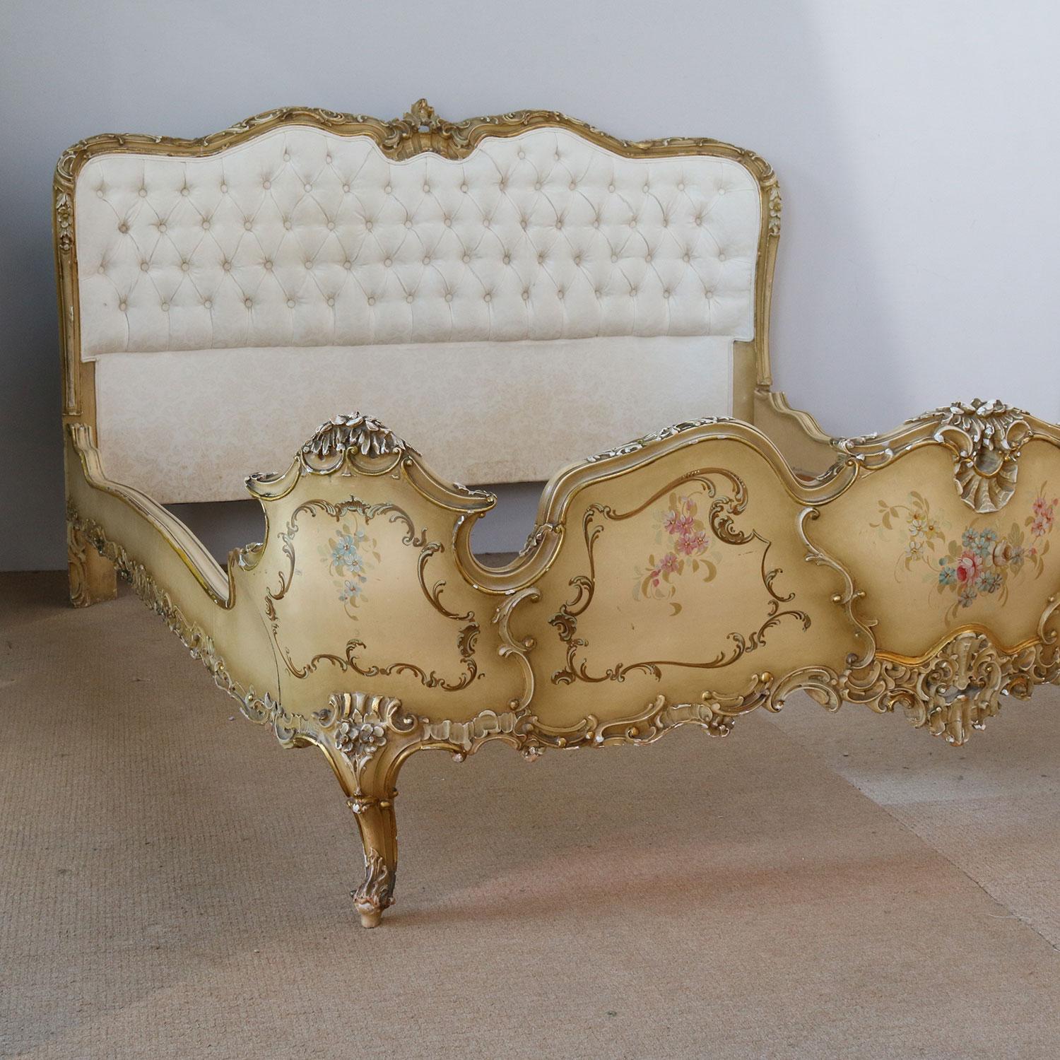 A magnificent Italian bed with a curved button-backed upholstered head panel and low shaped foot board. The frame work is gilded and painted with floral motifs.

This bed accepts an extra wide and shaped base and mattress set (approximately 67