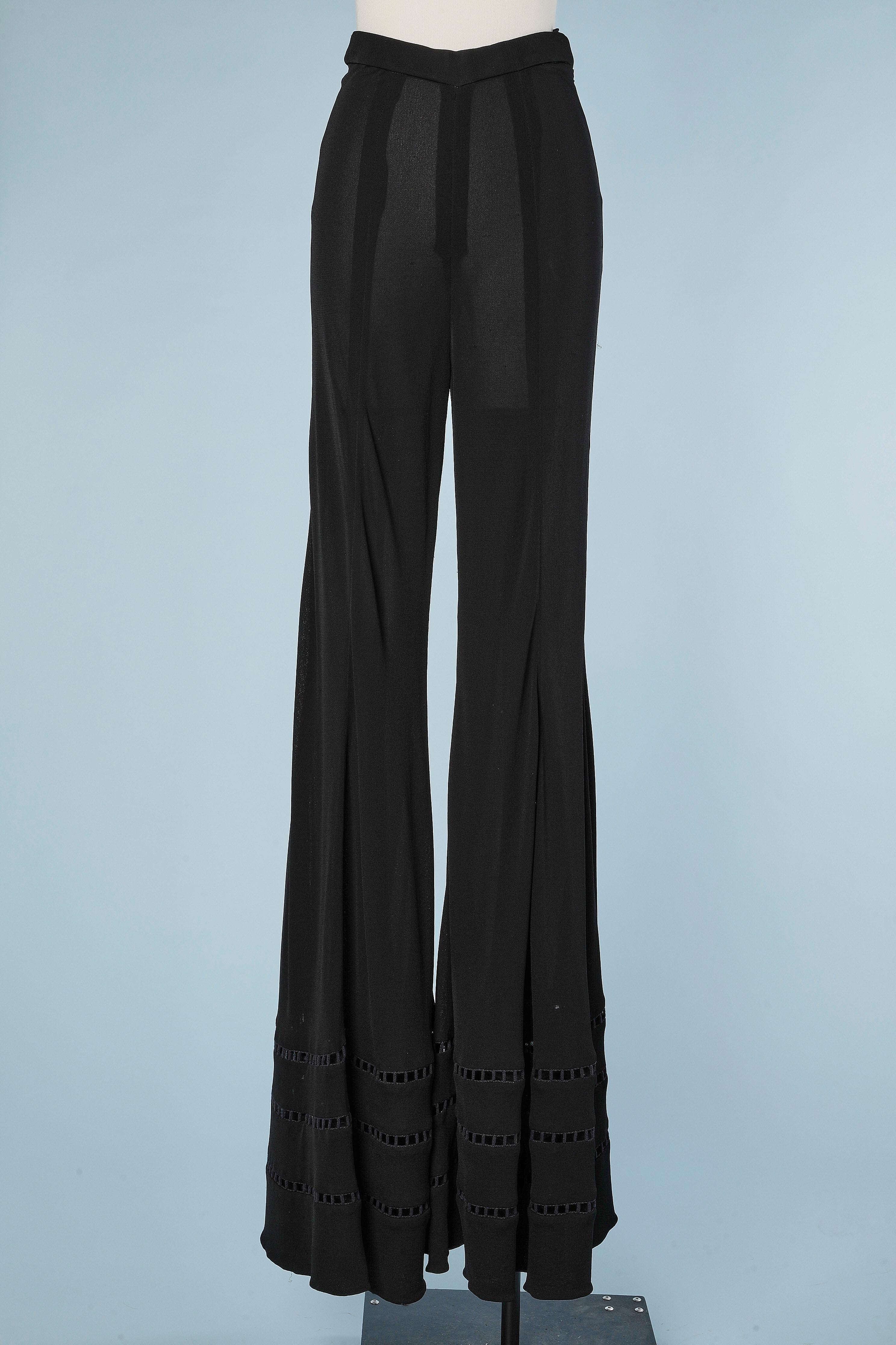 Wide-legs black crêpe jersey trouser with ajouré passementerie in the bottom. Zip on the left side. No lining. 
SIZE XS 