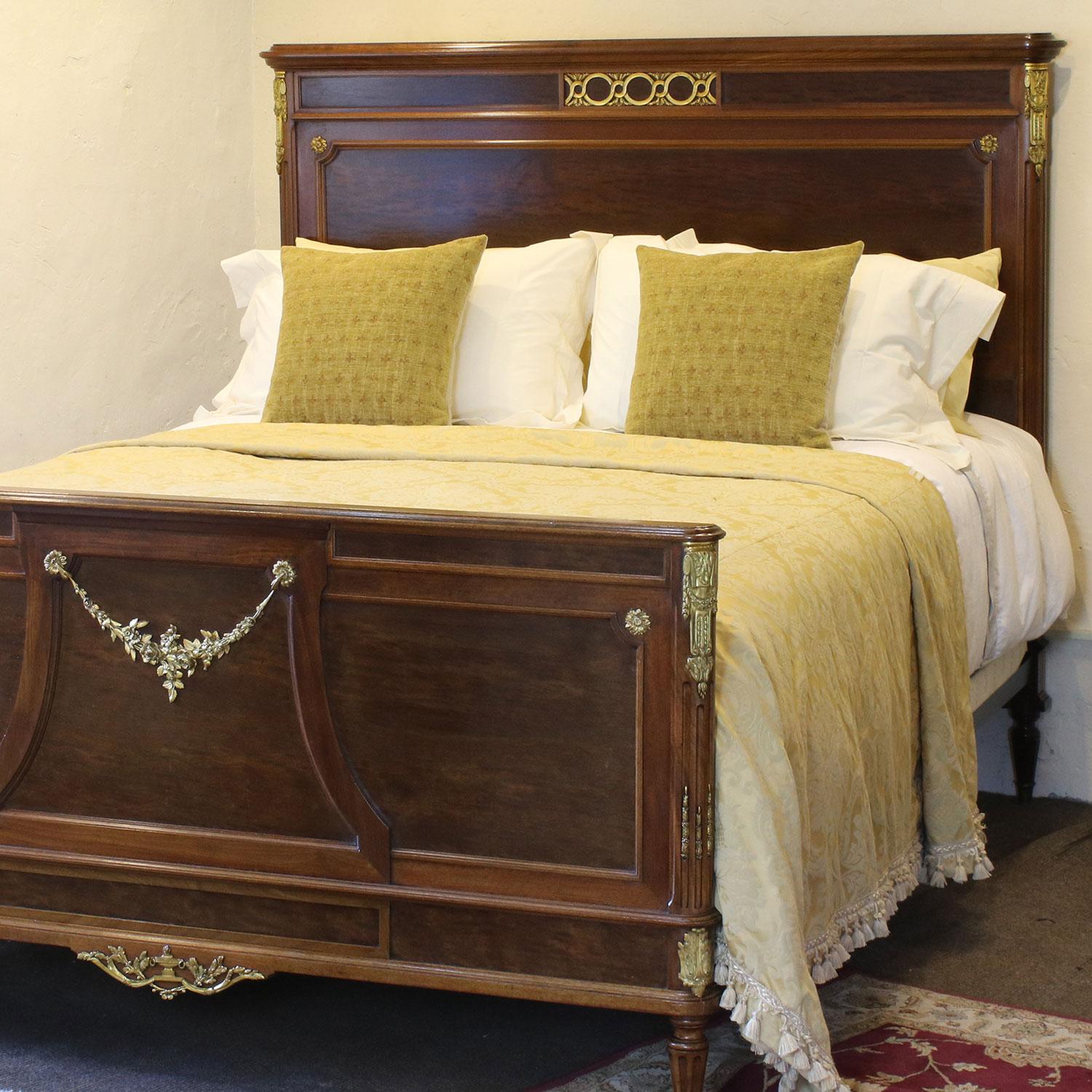 Magnificent mahogany bed from the early 20th century with ormolu decoration. 

This bed accepts an extra wide base and mattress set (5ft 3