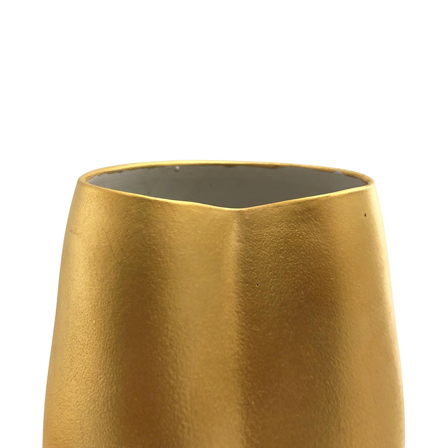 Wide mouth ceramic vase with dent in 22-karat matte crackle gold glaze by Sandi Fellman, 2019.

Veteran photographer Sandi Fellman's ceramic vessels are an exploration of a new medium. The forms, palettes, and sensuality of her photos can be found