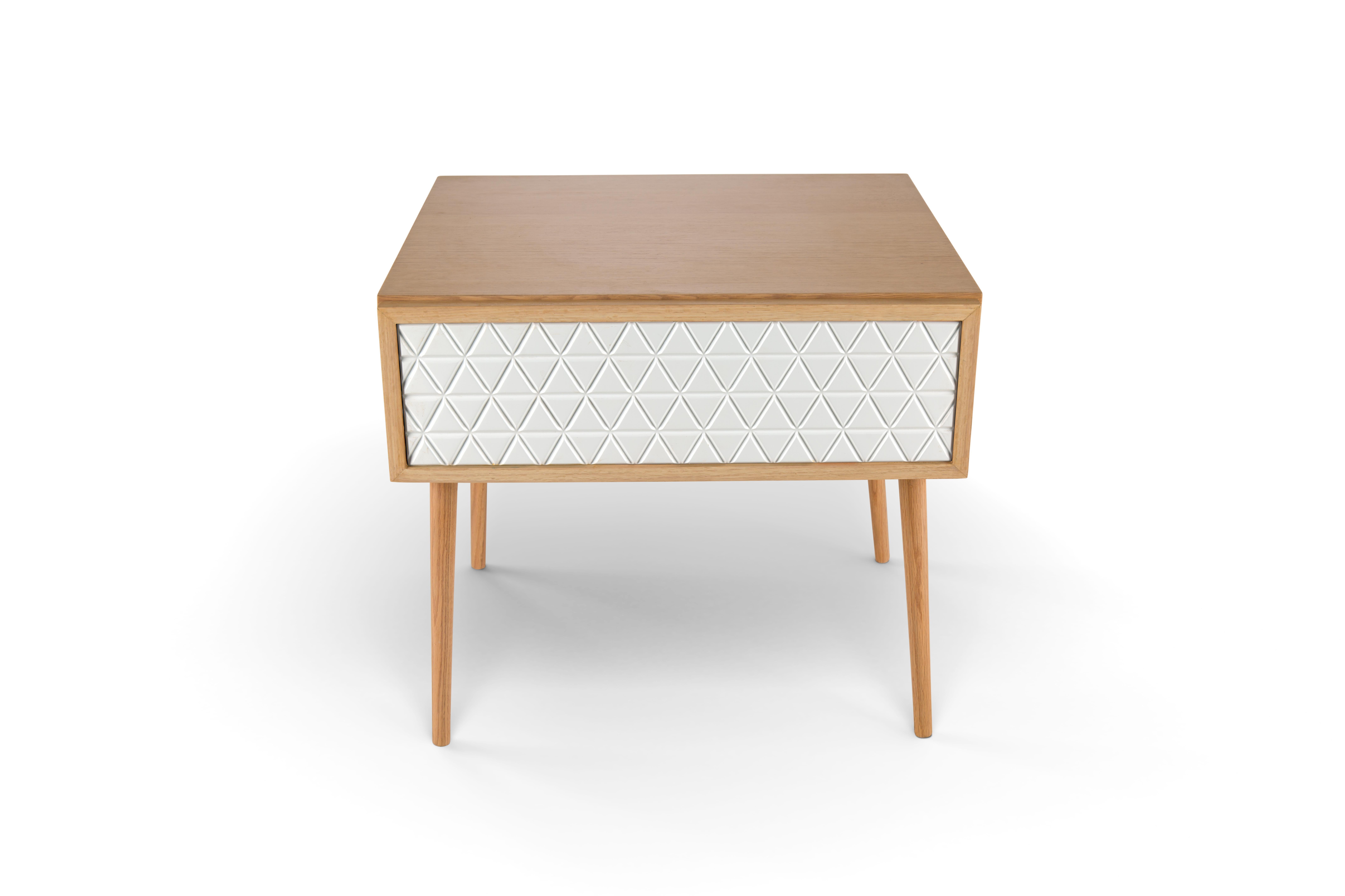 Wide oak wood nightstand with hand-crafted white lacquered drawer.
Our White Medley nightstand's body is made from Oak wood with a lacquered drawer hand-crafted with an intricate geometric design. The wide length is designed to allow ample space
