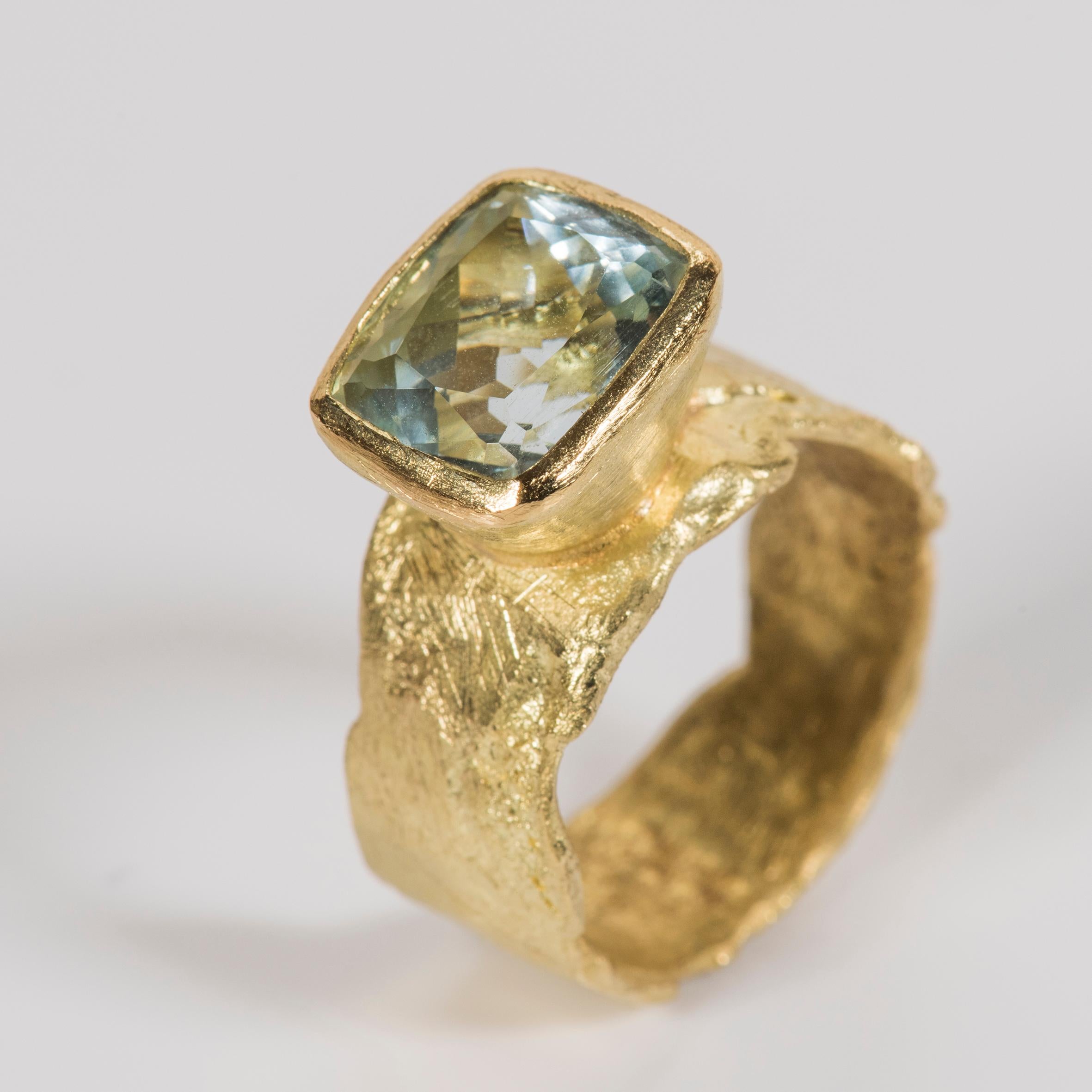 18k gold wide melted organic texture ring with 5ct cushion cut aquamarine. Disa Allsopp handmakes each ring using traditional reticulation and forging techniques. This means each ring has it's own character and unique texture. The aquamarine is
