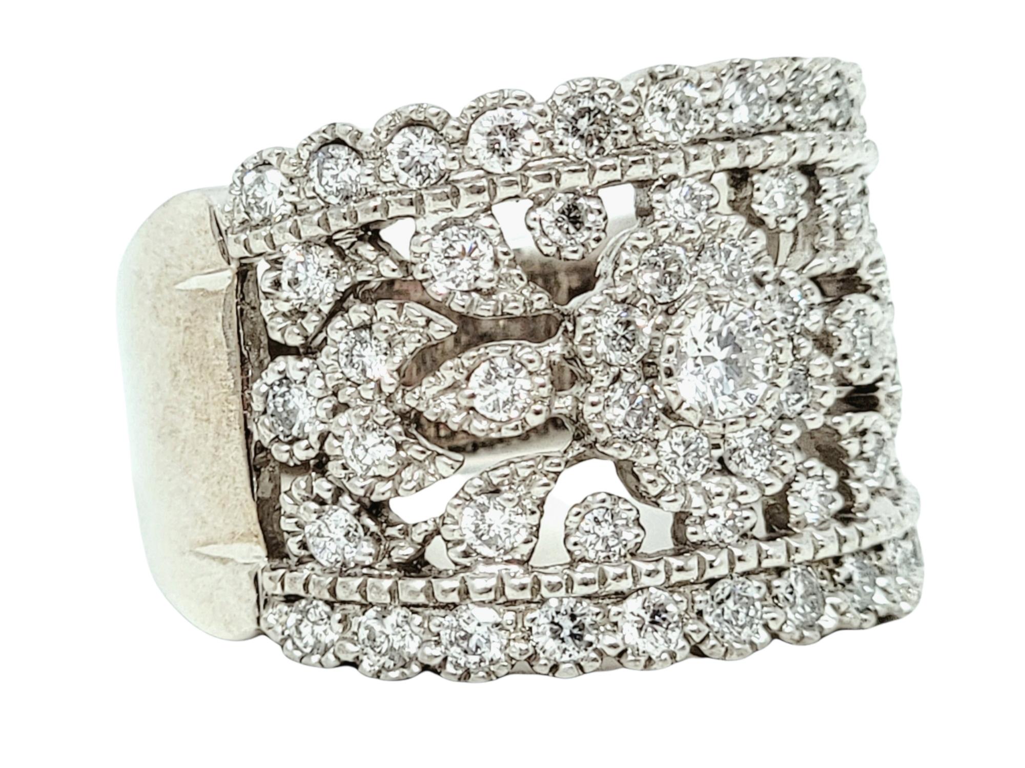 Ring size: 7.75

This beautiful, ornate diamond band ring fills the finger with shimmering sparkle. The flower cluster at the center is surrounded by intricate cut outs and subtle milgrain detailing, while the exceptional diamonds glitter from every