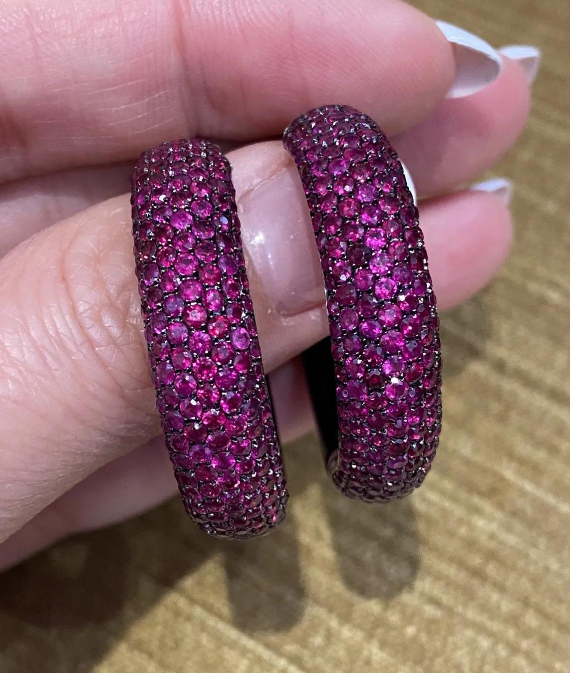 Wide Pave Ruby and Onyx Round Hoop Earrings in 18k White Gold

Ruby and Onyx Hoop Earrings feature 7.00 carats of deep pinkish-red Round Rubies pavè set in 7 rows on the front half of the earring, with Black Onyx on the back part of the earring, all