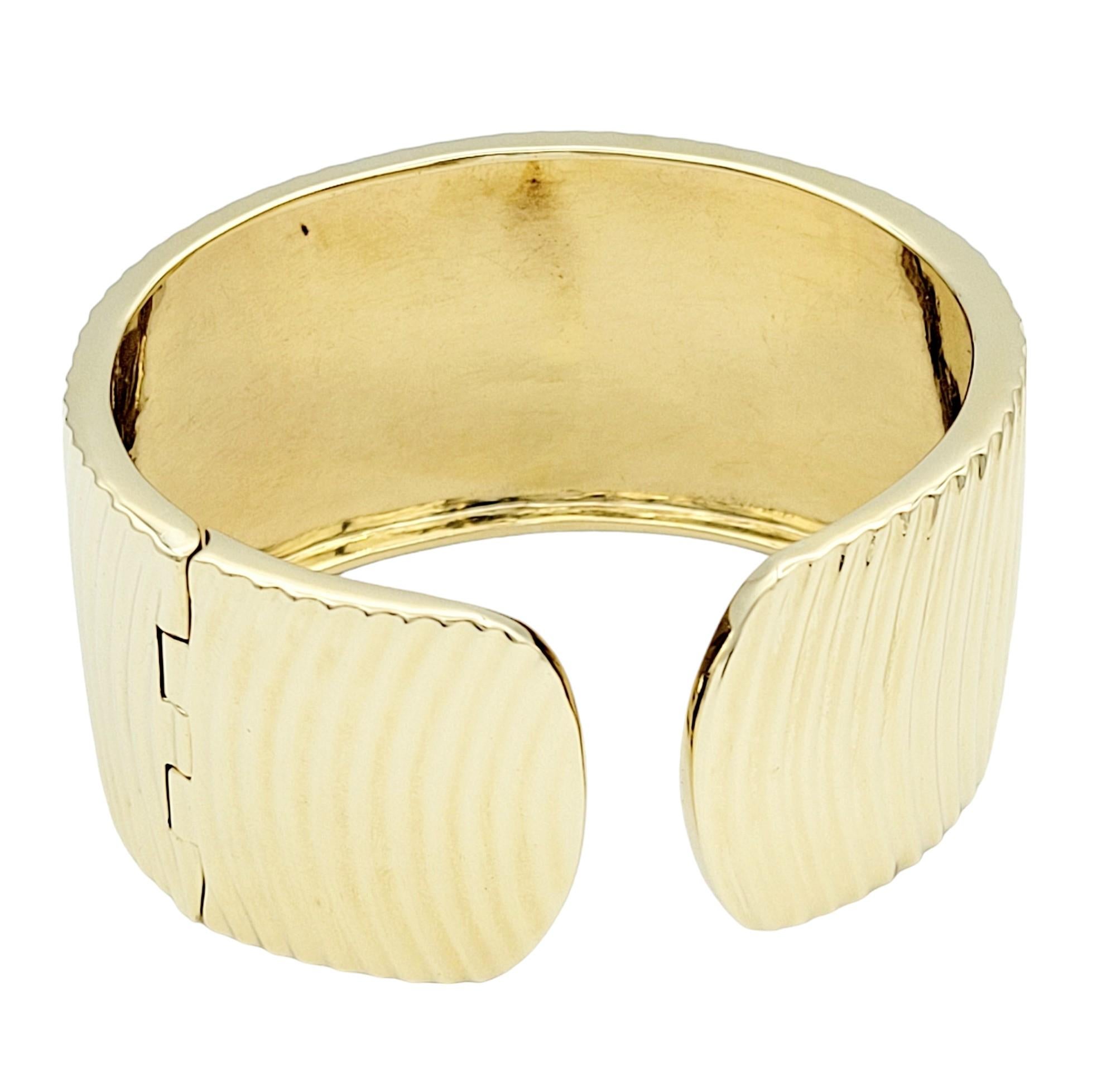 Wide Ridged Cuff Bracelet with Hinge Opening in Polished 14 Karat Yellow Gold  In Good Condition For Sale In Scottsdale, AZ