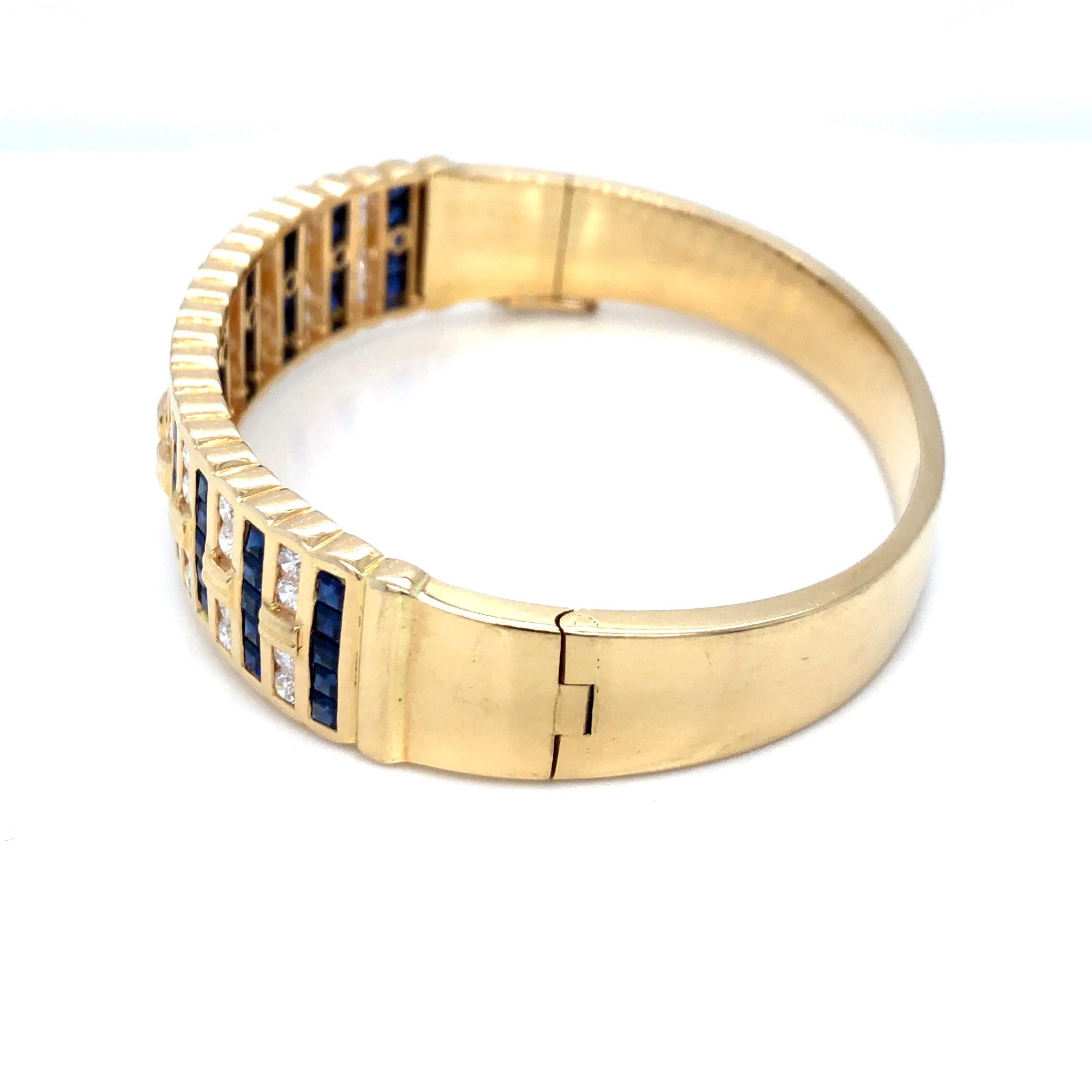 Wide Sapphire and Diamond Bangle Bracelet in 18K Yellow Gold. The bracelet features channel set 55 square cut sapphires and 40 brilliant round cut diamonds.
0.50