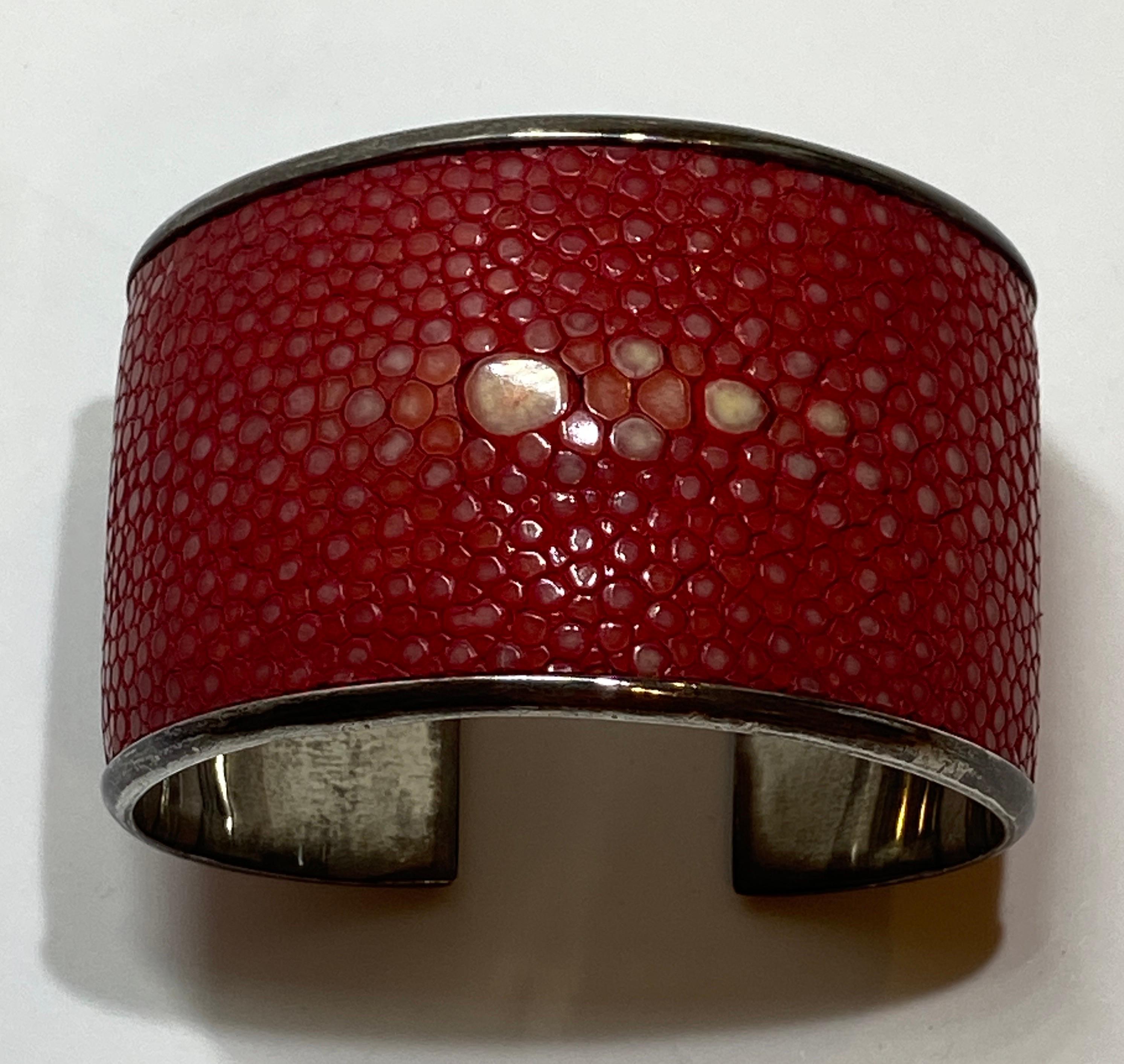 This wonderful bold statement sterling-silver cuff iis accented with shades of reds and creams dyed stingray skin. The interior is marked 