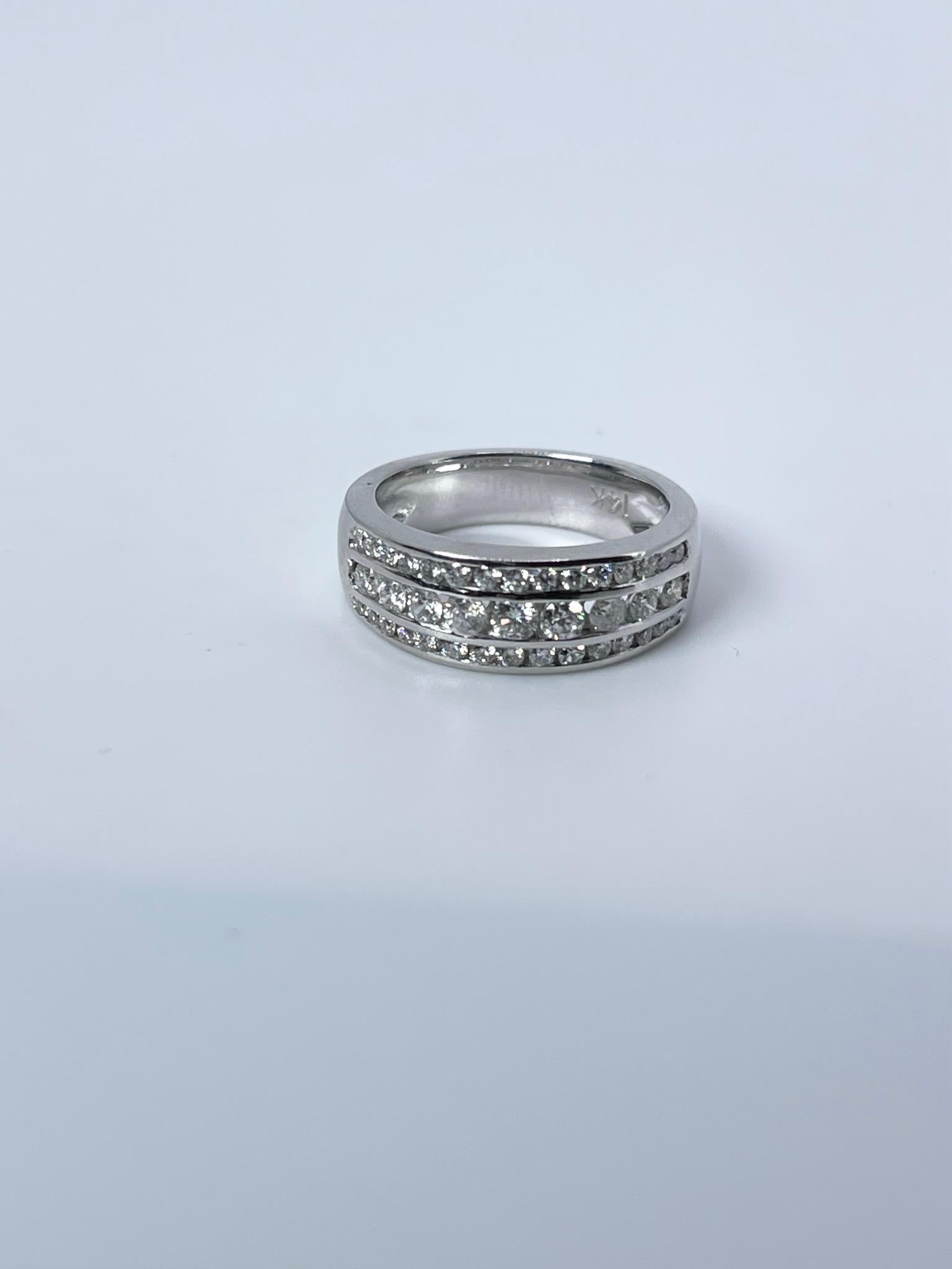 Wide wedding band 14KT white gold channel set diamond ring.
ITEM#: FPP 130-00023
GRAM WEIGHT: 7.71gr
METAL: 14KT

NATURAL DIAMOND(S)
Cut: Round Brilliant
Color: F-G
Clarity: VS-SI 
Carat: 0.75ct
Size: 6.5 ( can be re-sized)


WHAT YOU GET AT STAMPAR