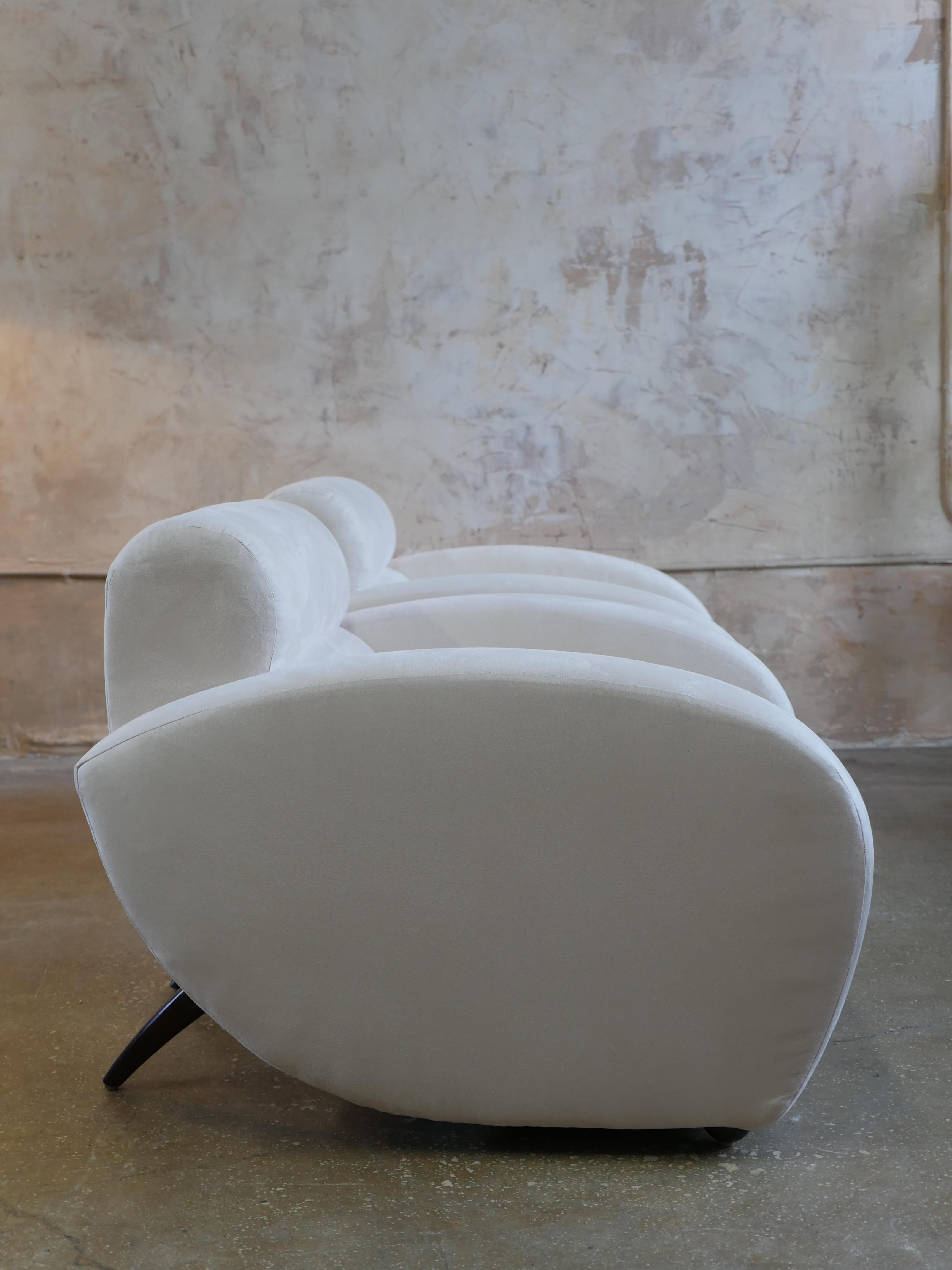 Pair of Weiman/Preview Furniture lounge chairs with their original ivory utrasuede fabric and rich mahogany wood legs. The lounge chairs have a sleek and graceful design reminiscent of Vladimir Kagan that is sure to add a touch of cool and elegance