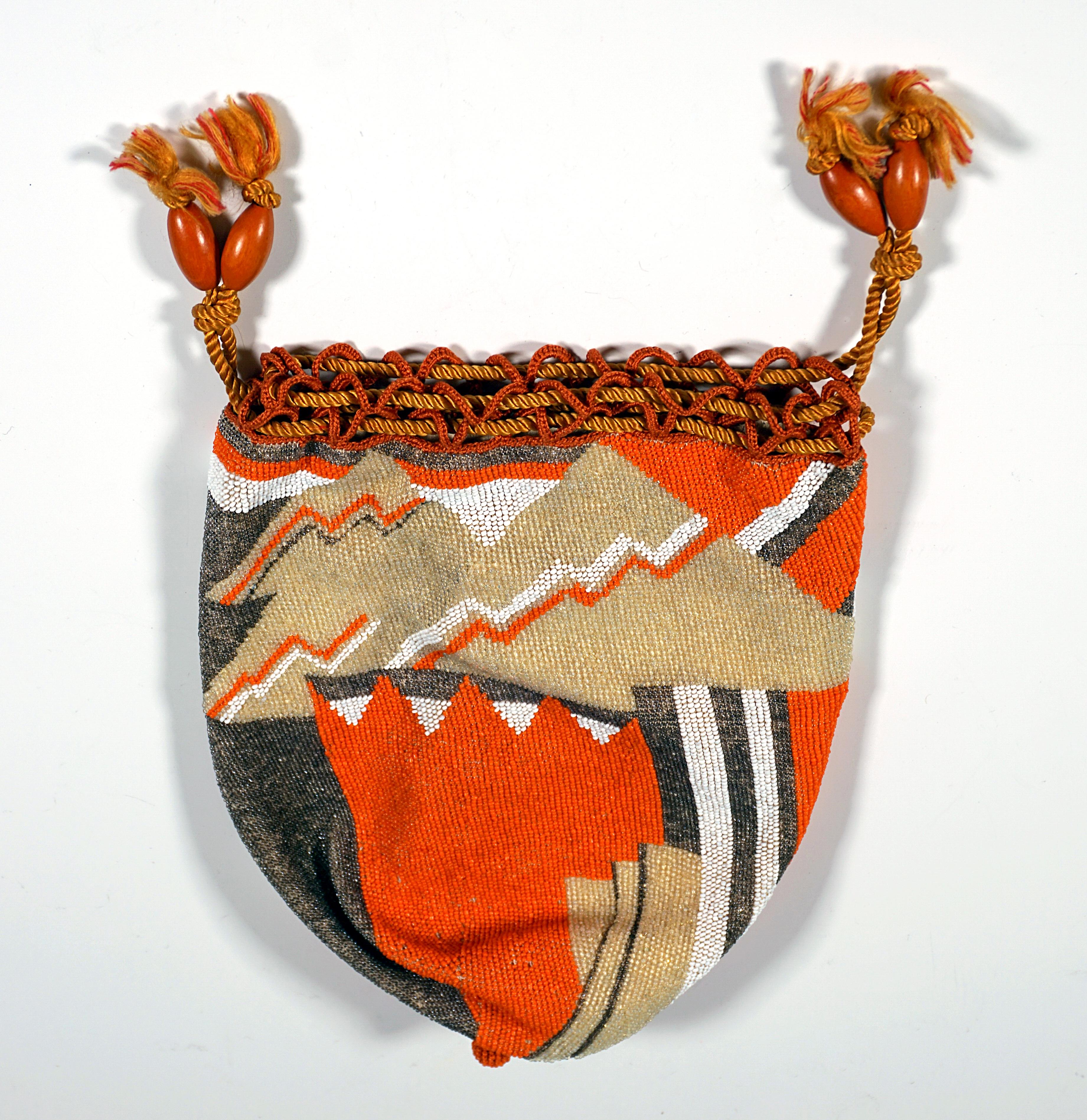 Exceptional, rare pouch bag with abstract bead embroidery in bright orange, beige, dark brown and white, crocheted at the upper edge, cords as drawstrings with olive-shaped wooden beads, lining made of light-coloured goatskin.
Design attributed to