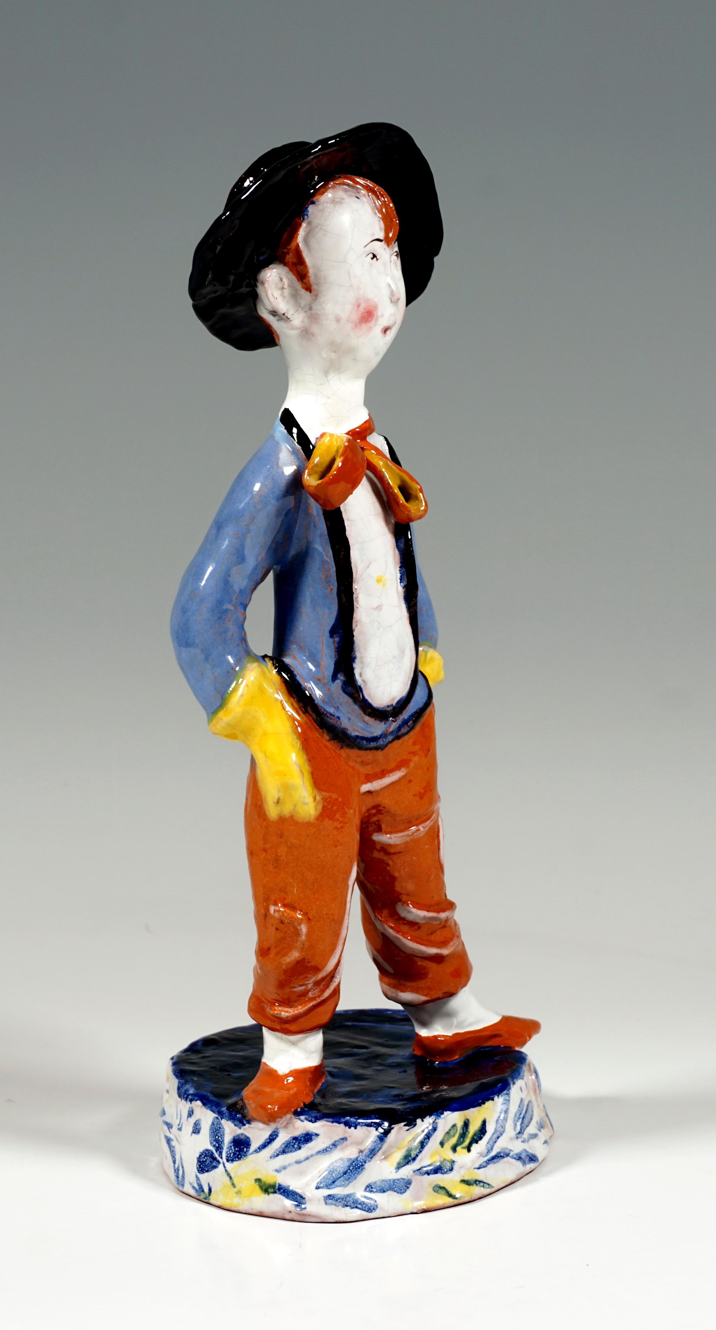 Boy with a wide-brimmed hat standing upright and legs apart, both hands hidden in his trouser pockets, low-cut jacket, long, wrinkled trousers, tied bow around his neck, his mouth open for whistling.
On a eled, relief side with blue, floral