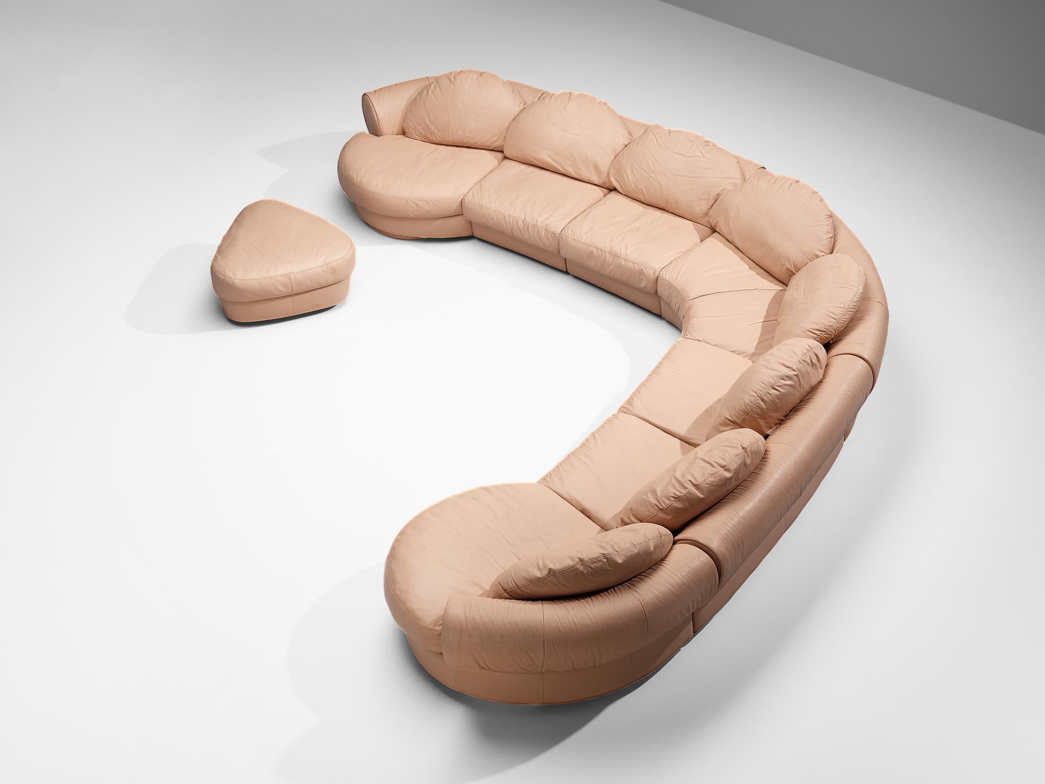 Attributed to Wiener Werkstätte, modular sofa, leather, plastic, Austria, 1970s.

This sofa is fully executed in a salmon pink leather that contributes to a unified look. The construction consists of seven elements and a matching ottoman, which