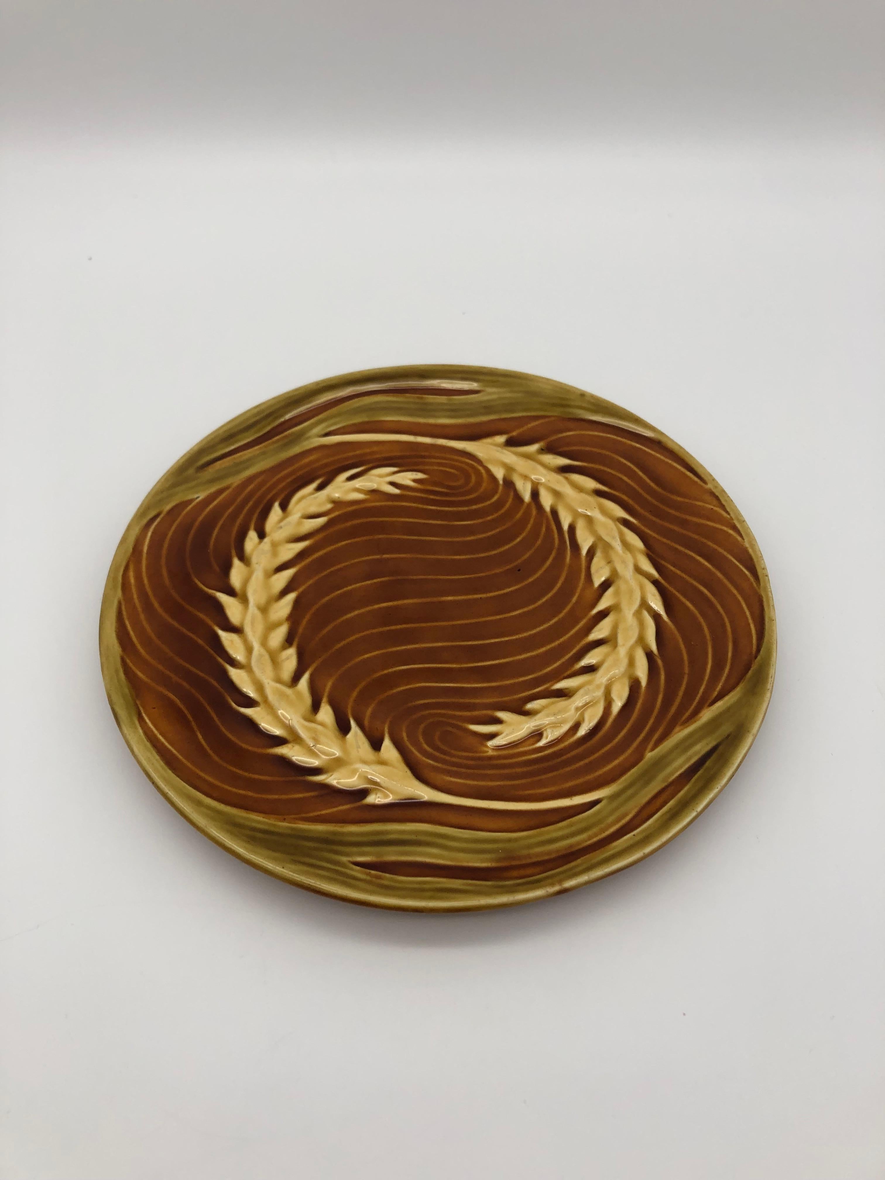 Ceramic plate with 3 dimensional grain design. 
You can see the wonderful handwork in the design and colours.

Design and execution by Jutta Sika, a Student of Koloman Moser.
On the underside of the plate is stamped 