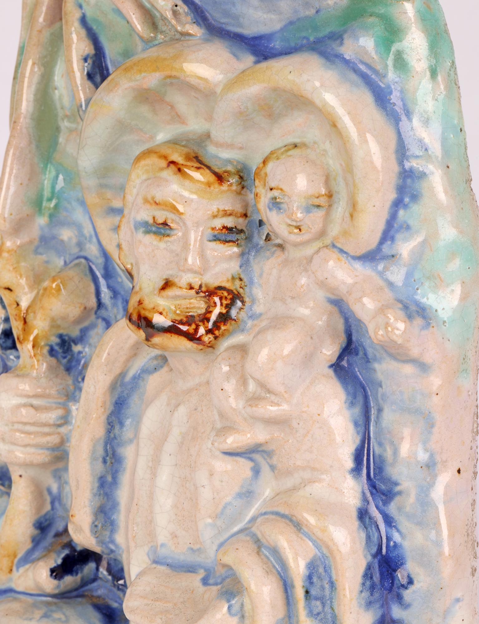 An unusual Austrian art pottery sculptural figure of St Christopher carrying the Christ child across a river attributed to renowned Austrian sculptor, Ceramist, designer and teacher Michael Powolny (Austrian, 1871-1954) and probably dating between