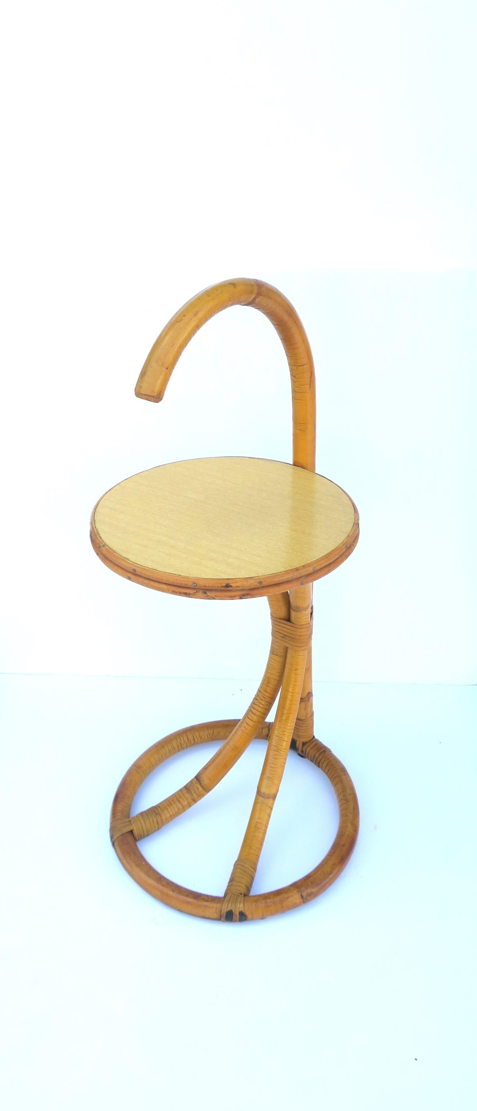 A wicker rattan side drinks table, circa mid-20th century. Table is wicker wrapped rattan with laminate tabletop. A great table for indoors or outdoors, patio, pool, etc. (I wouldn't leave table out during inclement weather.) A convenient table to