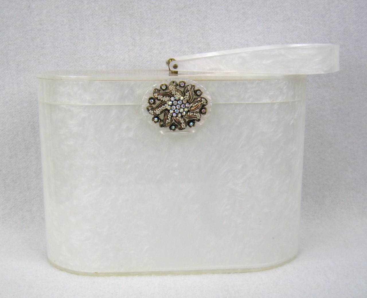1950s Wilardy Opaque, Marbled White Lucite Purse, Ornate Clasp, Great Handel Mirror inside top of handbag with a Stunning Pearl and Crystal Decorative clasp. Measuring  10 WIDE X 5 DEEP X 7 TALL --6 inches TALL HANDLE. This is out of a massive