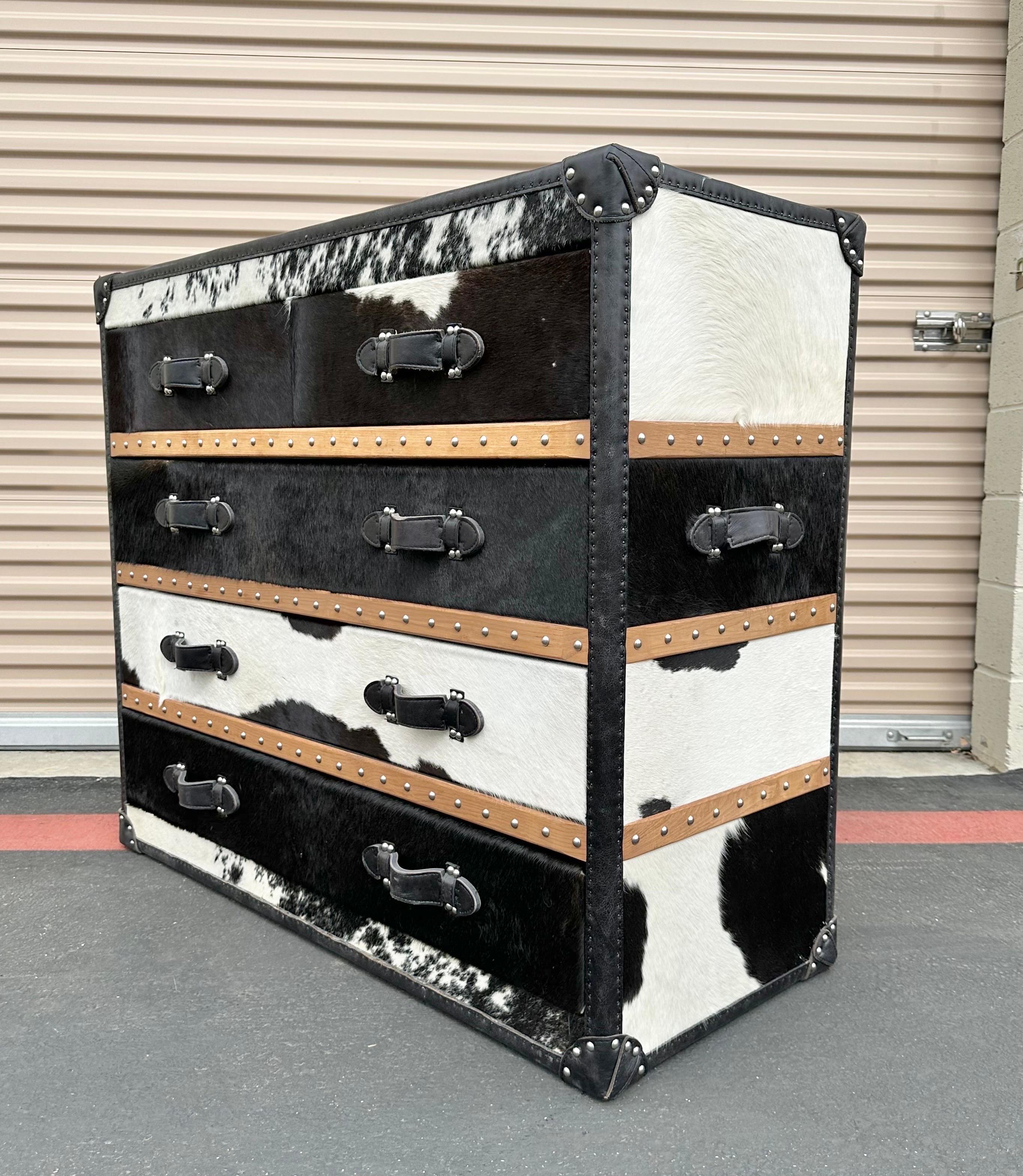Spectacular Black and White Cowhide Long Chest handcrafted. Made in Italy in 2018. Made of solid teak wood, black and white cowhide, black leather handles and polished  stainless steel nails,  It also have fabric inside the drawers. Five drawers,