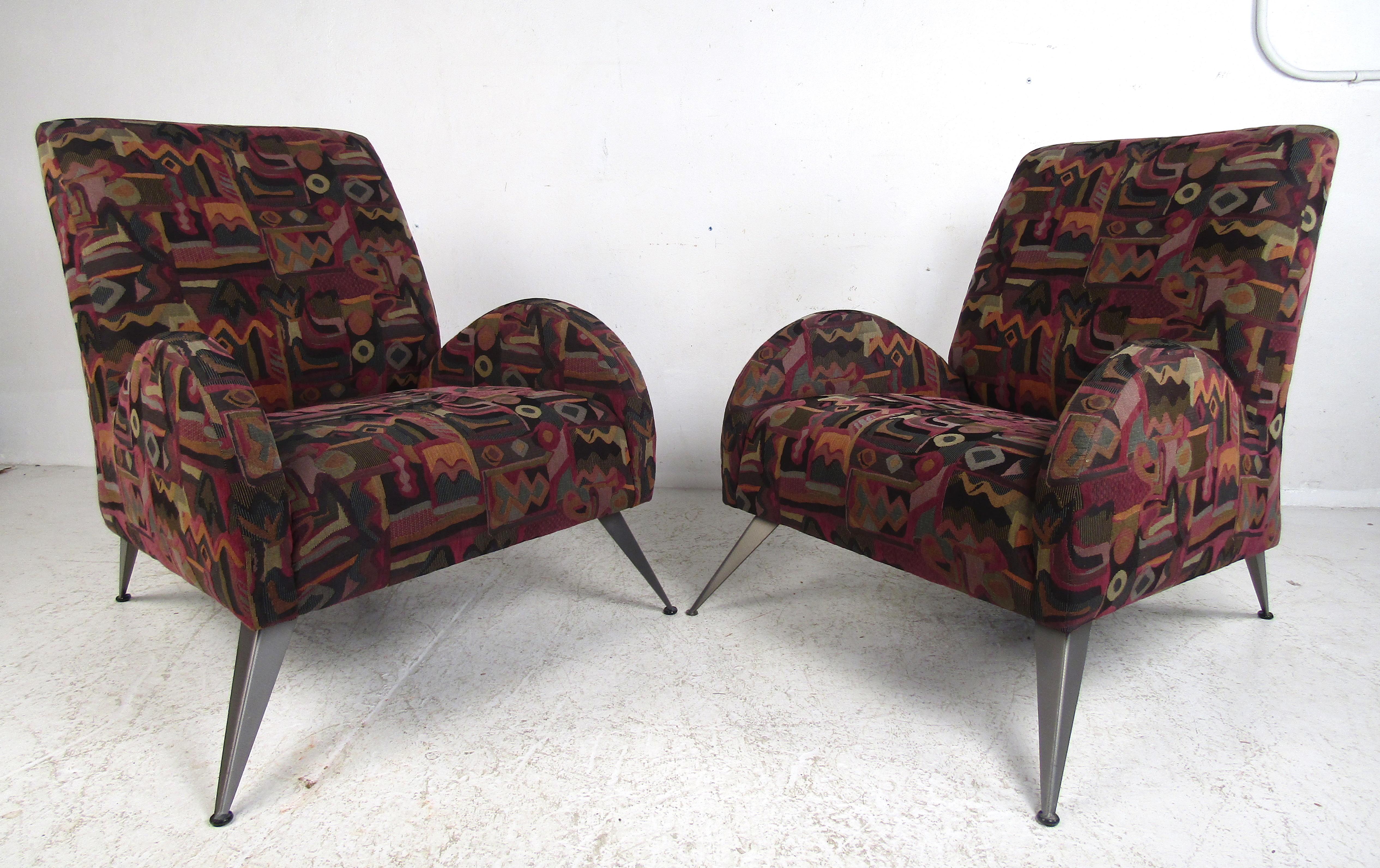 This beautiful pair of Italian modern lounge chairs boast unusual splayed metal legs and unique ellipse-shaped armrests. A wild Art Deco/midcentury style design that ensures maximum comfort in any setting. The extremely soft fabric has wonderful