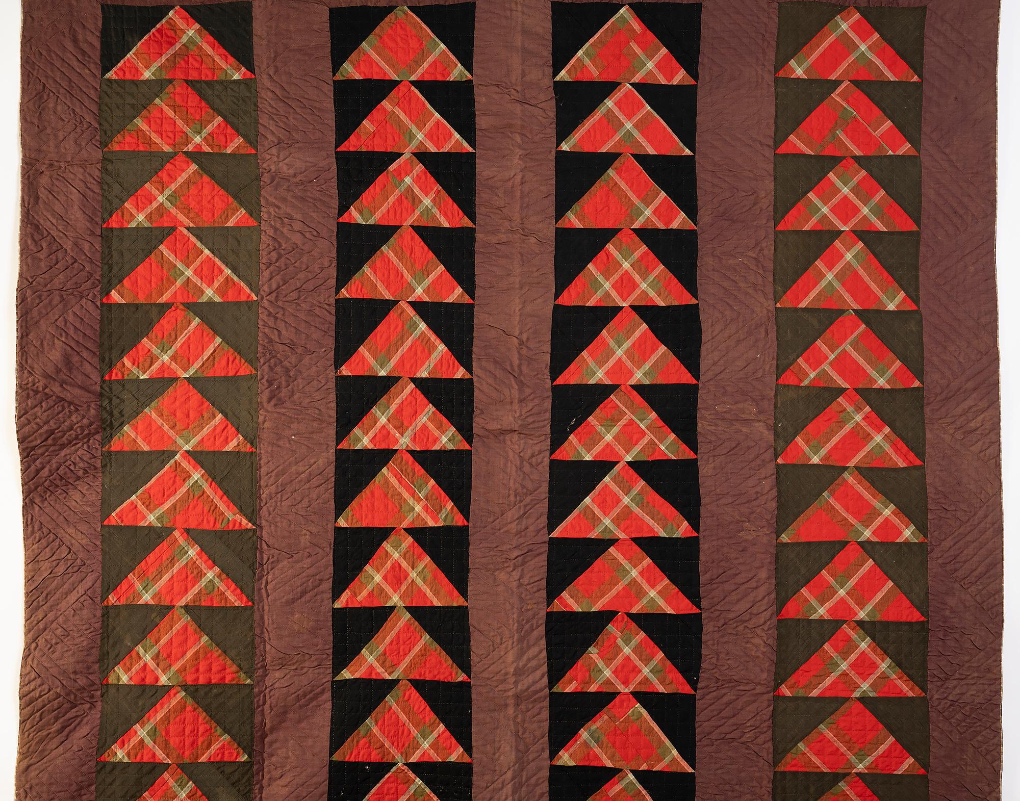 Wild goose chase quilt made of fairly heavy wool fabrics with a plaid cotton backing. Made circa 1870; Maryland origin. The plaid triangles against the solid color bars give the illusion of tremendous movement to the geese. Measures: 85