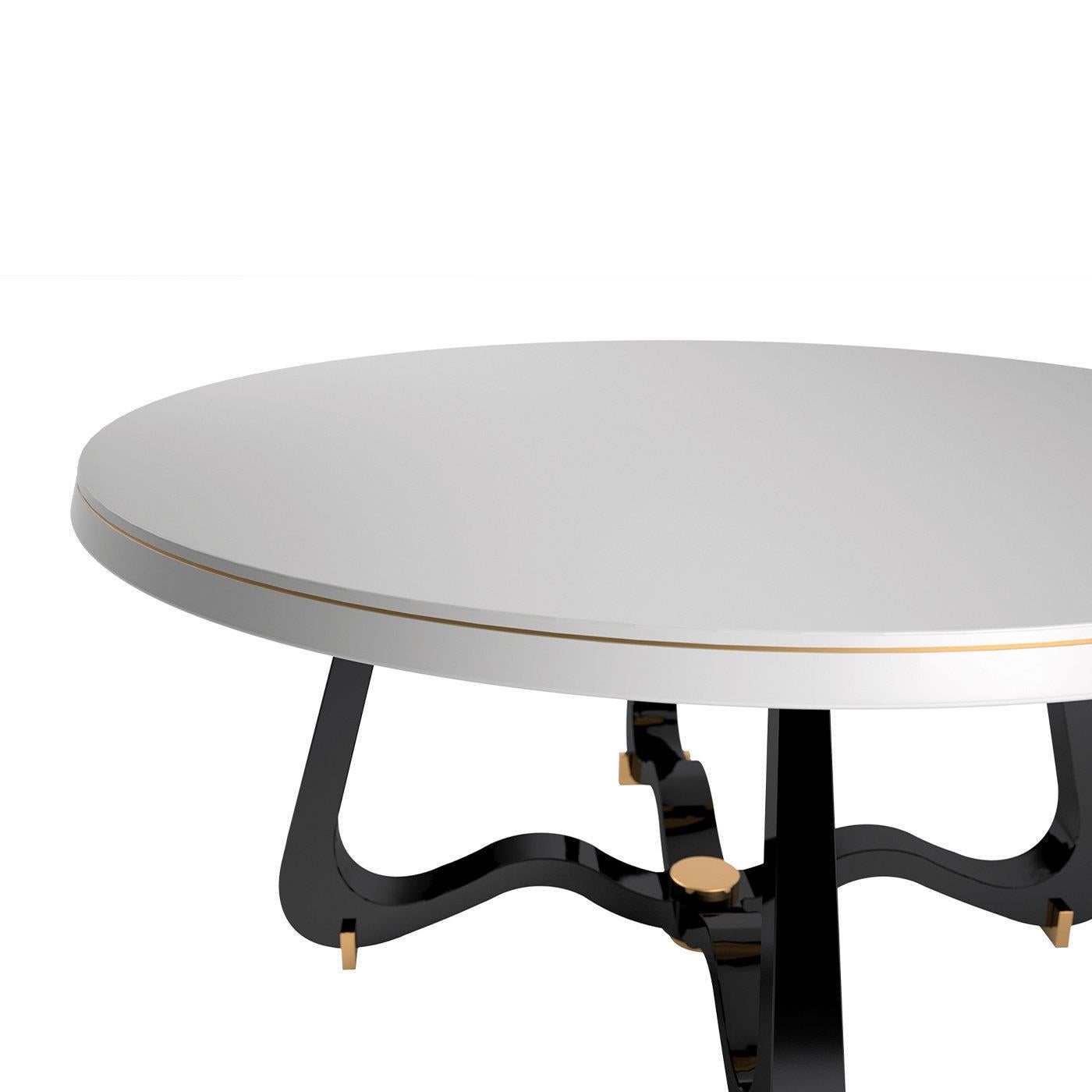 An exquisite combination of black and white polished hues enhanced with shiny brass details, this magnificent dining table will make a bold and stately addition to a refined contemporary interior. Designed by Giannella Ventura, it is fashioned of