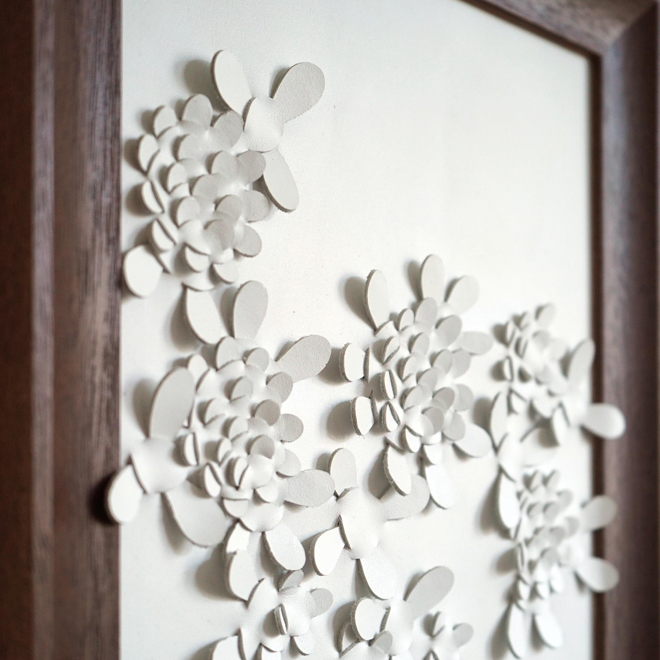 Wildflower:

A piece 3D sculptural of wall art designed and made from two layers of white leather, woven together by Louise Heighes.
Measurements are 11.6 x 14 inches or 29.5 x 35.5 cm

This piece is inspired by the striking yellow wildflower and