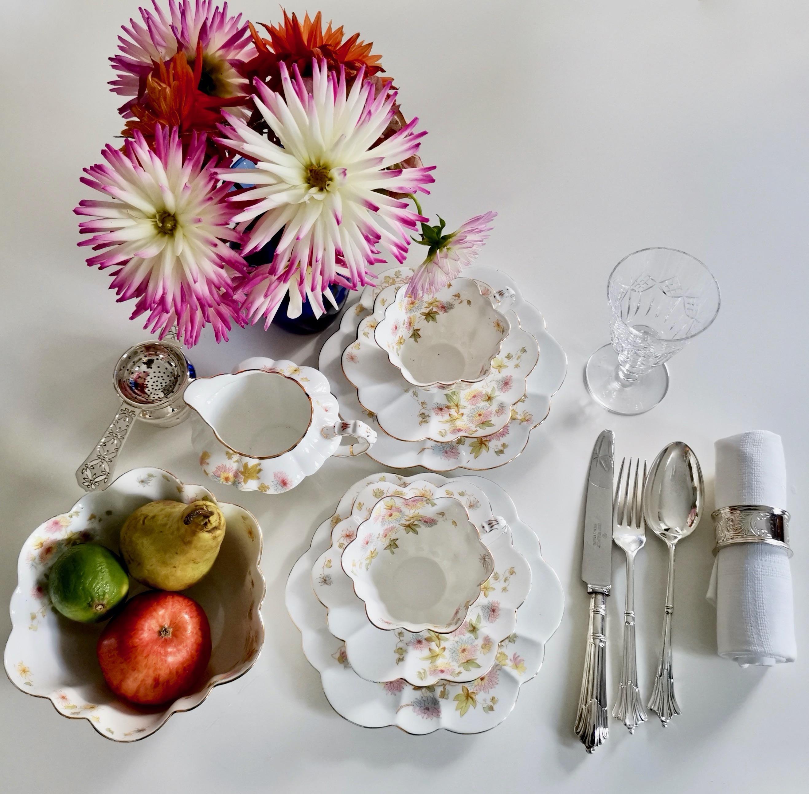 This is a beautiful tea-for-two set (or tete a tete) made by Wileman in 1896. The set consists of two teacup trios, a milk jug and a slop bowl.

The set is printed with the Chrysanthemum pattern in polychrome, a very fresh combination of pastel