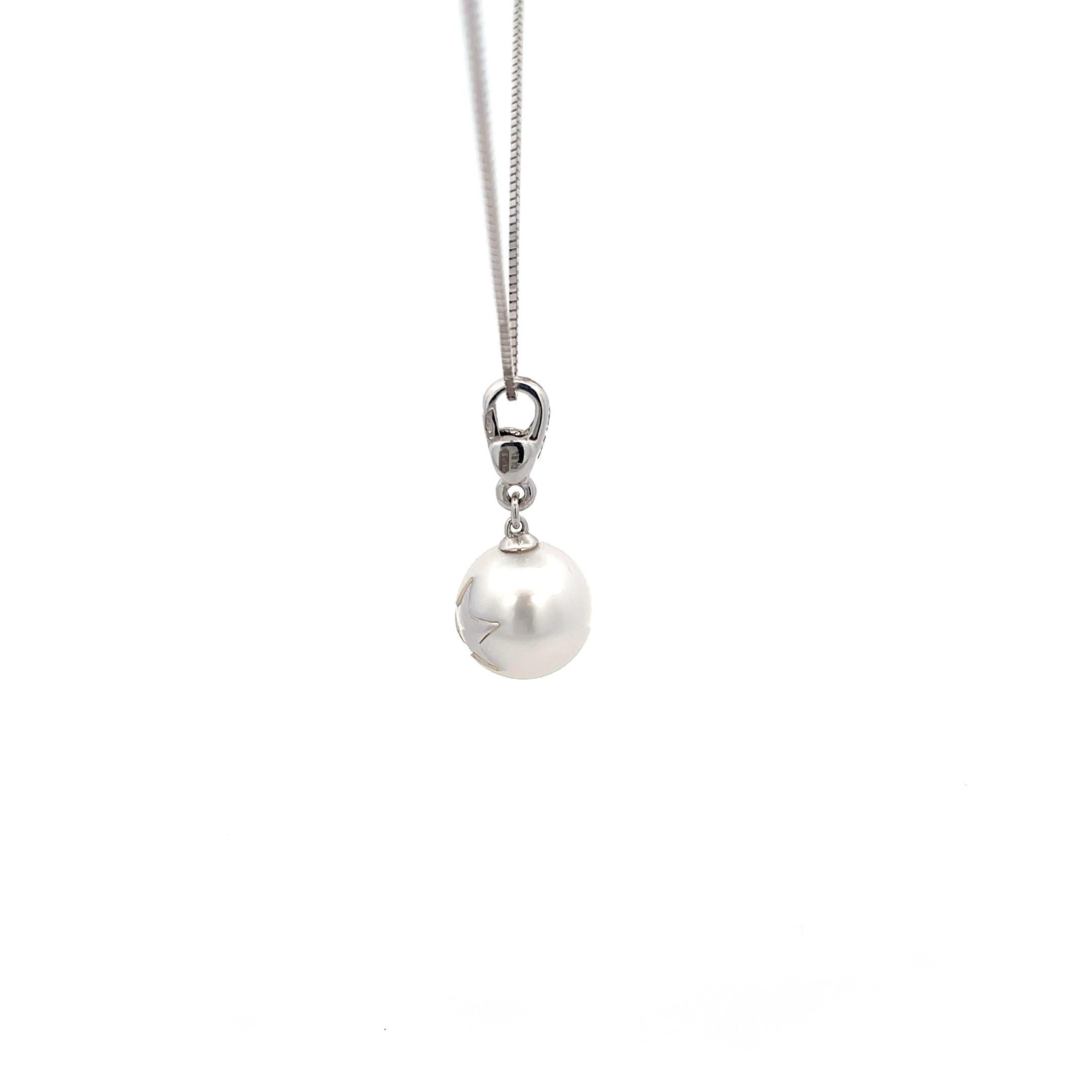 Wilfredo Rosado South Sea Pearl Charm with Star Symbol in 18K White Gold. The pearl charm features a patented process of inlaying 18k gold. The pearl is approximately 10.9mm. CHAIN NOT INCLUDED.
