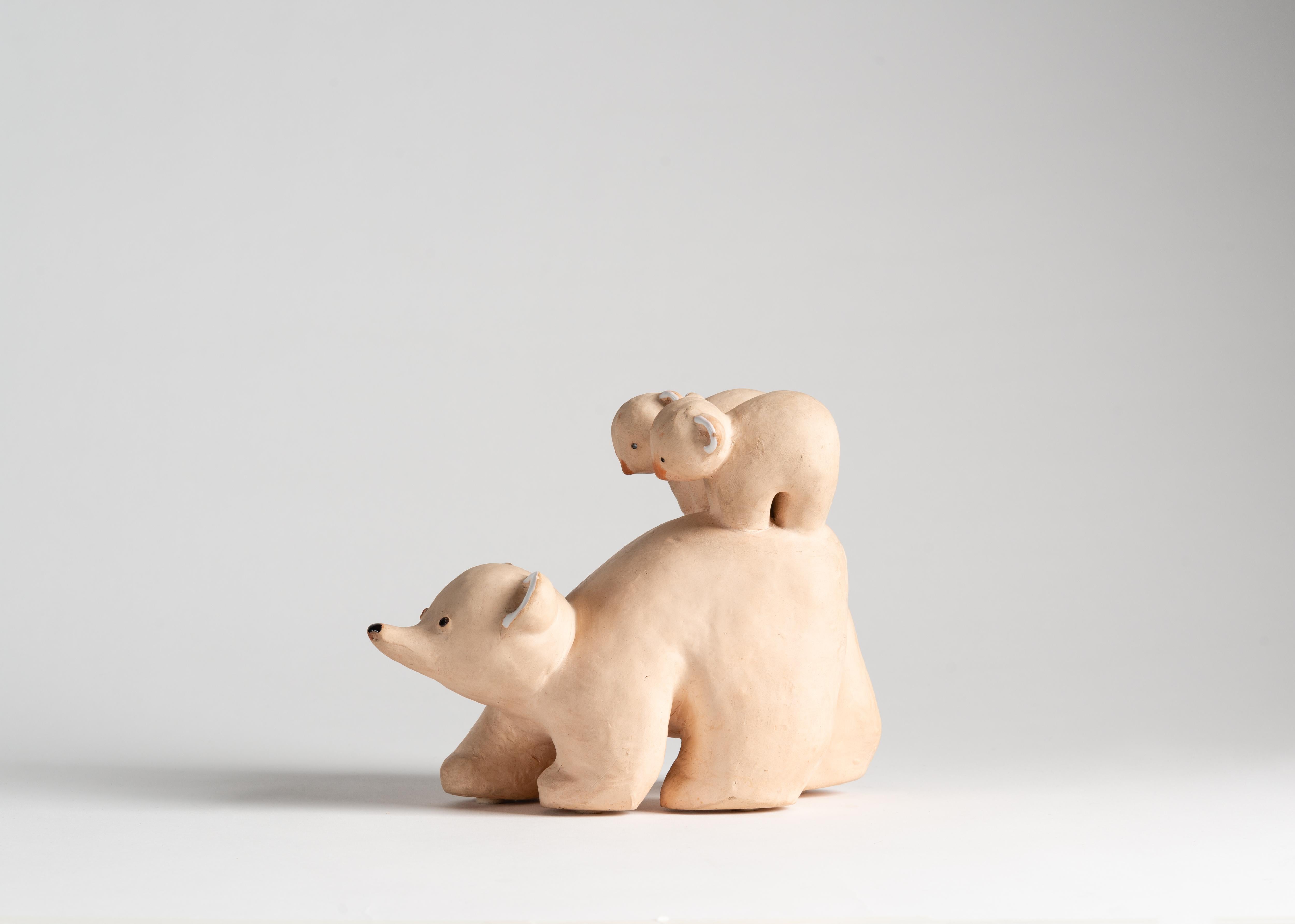 This playful ceramic sculpture of two cubs riding atop their mother's back emanates warmth with its subject, form, and color. 

 