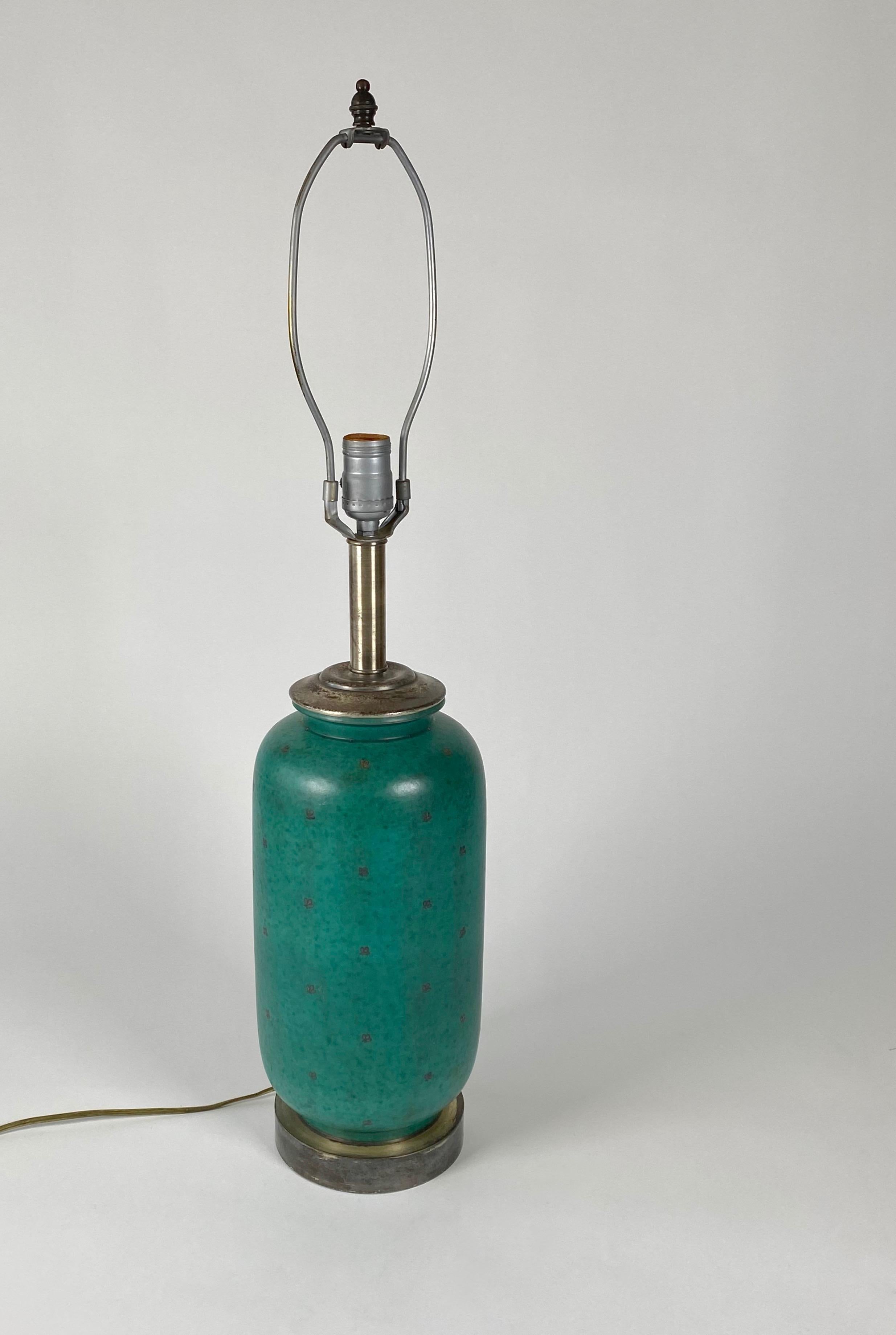 Table lamp by Wihelm Kage for Gustavsberg, Sweden in Argenta Green Stoneware with sterling silver embellishments of small leafs in all original condition unpolished with patina. Beautiful green color contrasts against patinated silver in its