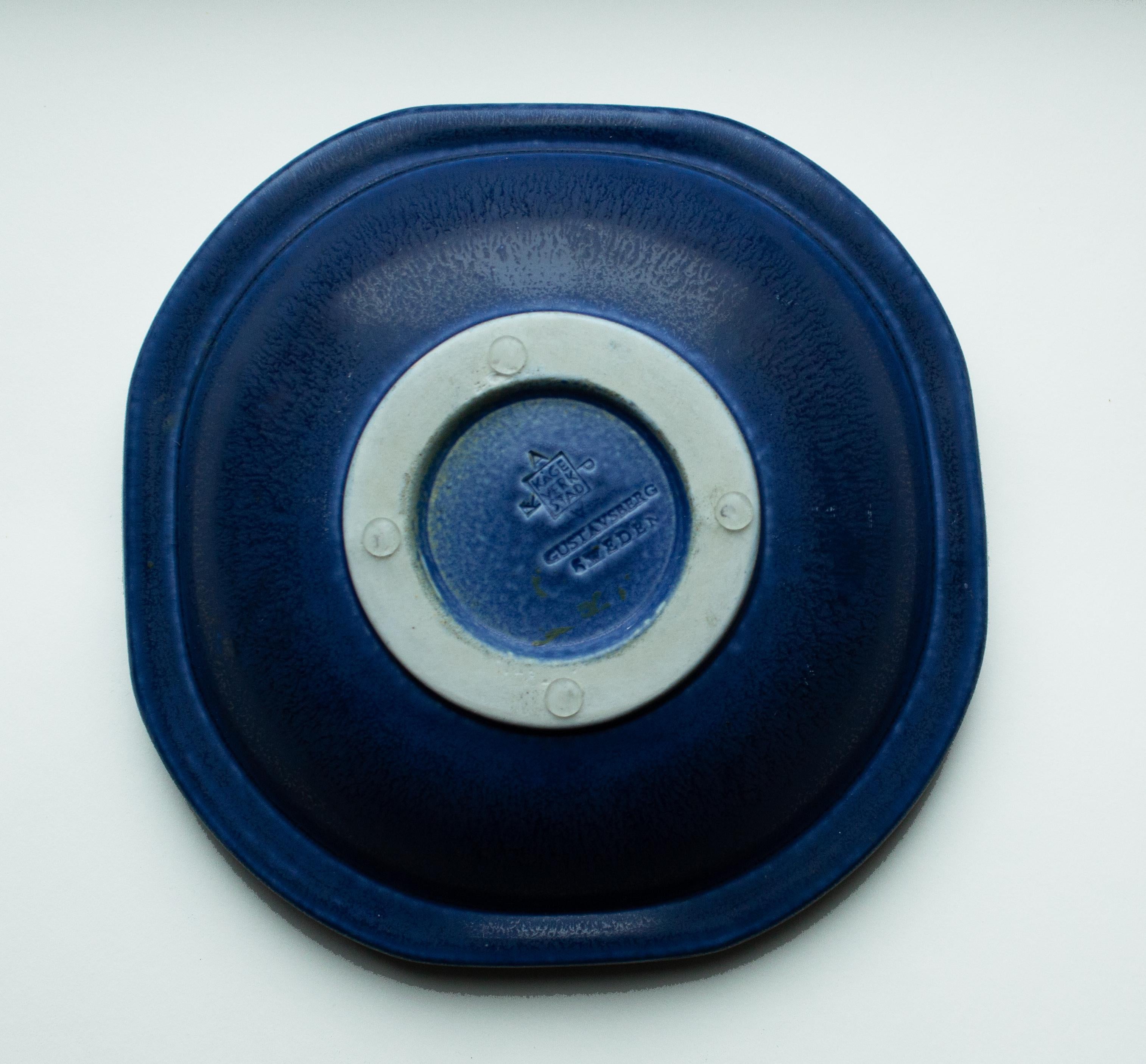 Wilhelm Kåge Blue Bowl in Stoneware from 1958, Gustavsberg, Sweden. Wilhelm Kåge's bowl with a gently octagonal form, blue glaze, and relief decor. It was designed in 1958 at his Gustavsberg studio. A brilliant art piece from the Swedish