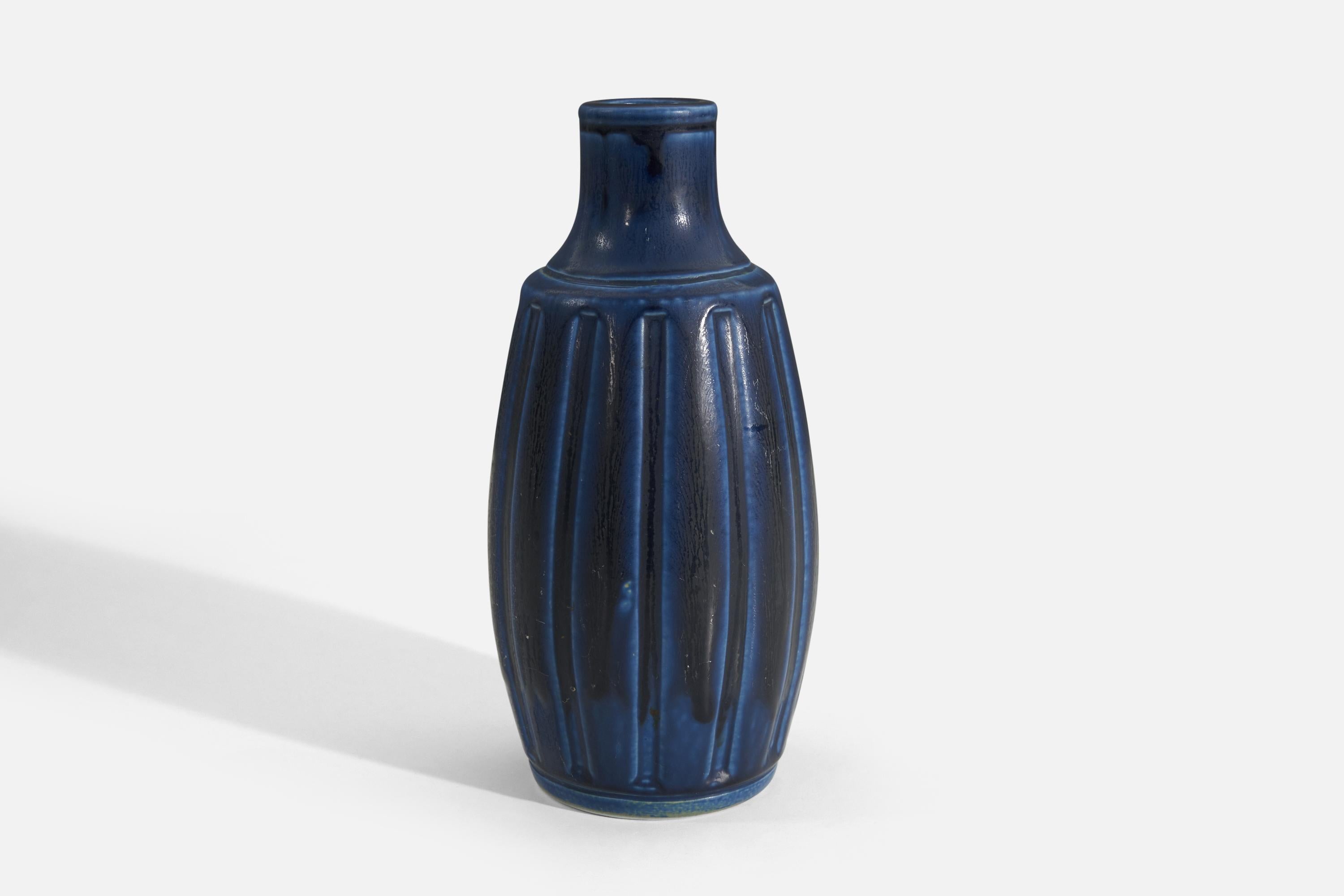 A fluted blue-glazed stoneware vase designed by Wilhelm Kåge and produced by Gustavsberg, Sweden, c. 1950s.

