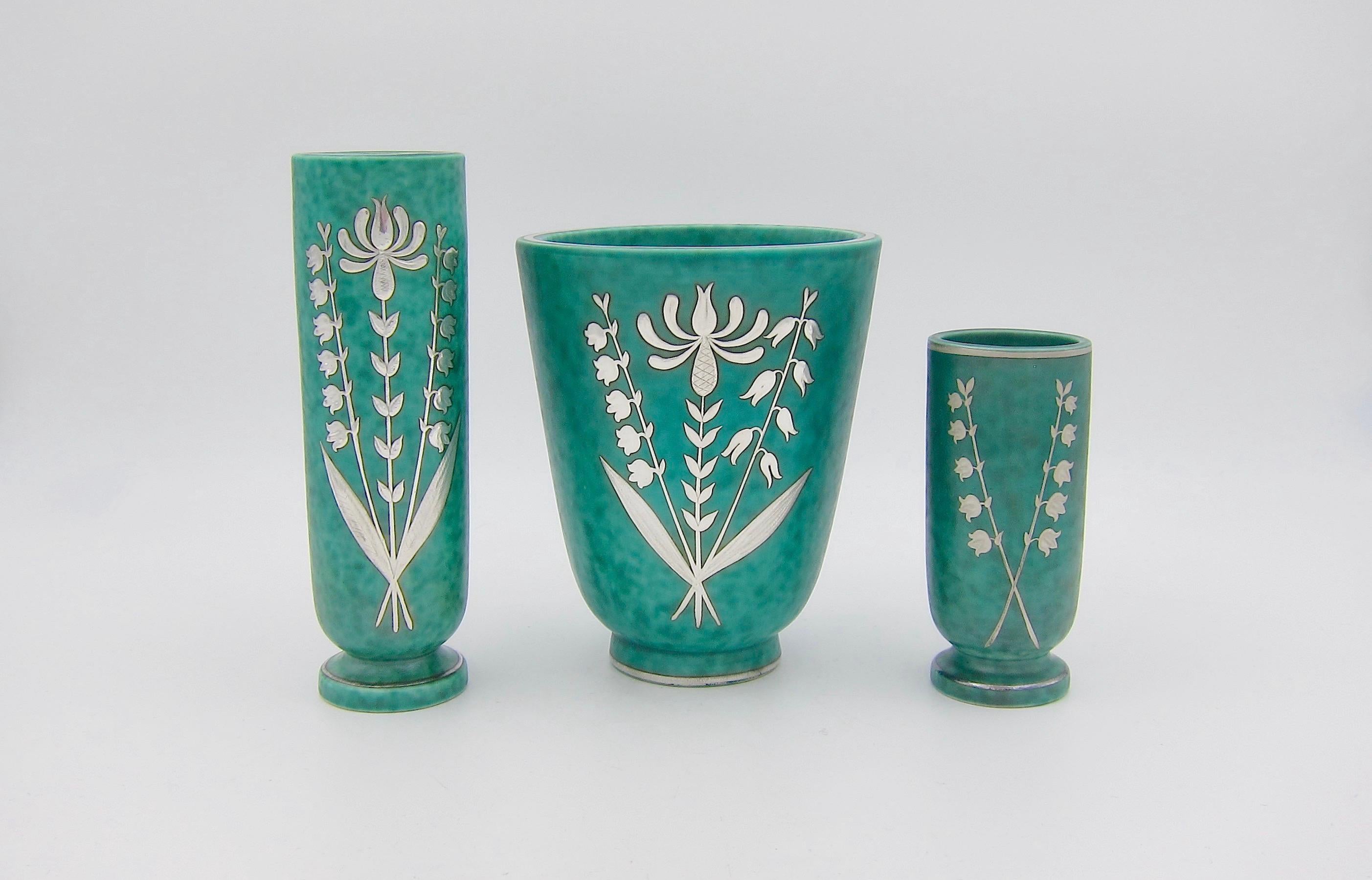 A vintage Scandinavian vase trio from the Gustavsberg Porcelain Factory of Sweden, designed by Swedish artist, painter and ceramist, Wilhelm Kåge (1889-1960), the artistic director of Gustavsberg from 1917 until 1948. These Art Deco vases are from