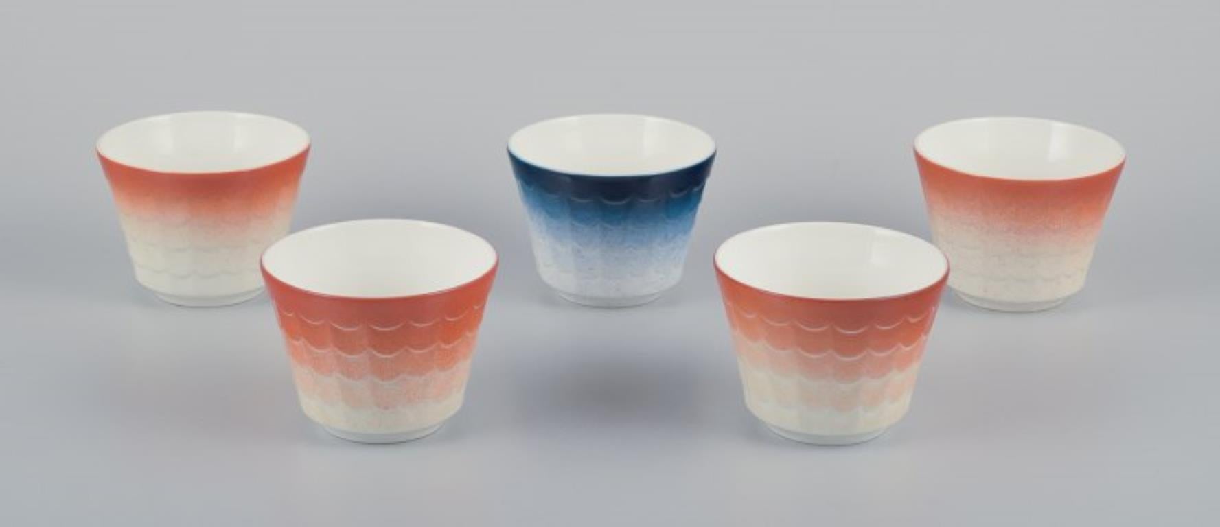 Wilhelm Kåge per Gustavsberg. Cinque vasi per piante in porcellana.
Design svedese. Smaltato in arancione e blu.
1960s.
In perfette condizioni.
Contrassegnato.
Dimensioni: 10,5 cm x 8,0 cm.
