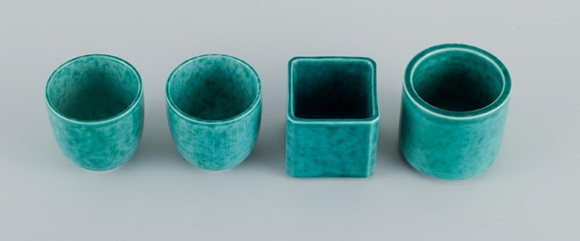 Wilhelm Kåge for Gustavsberg. Four Argenta Art Deco vases in glazed ceramics. 
Beautiful glaze in shades of green. Mid-20th C.
Largest measuring: H 6,0 x D 6,0 cm.
In excellent condition.
Unmarked.