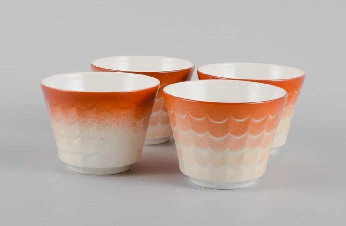 Wilhelm Kåge for Gustavsberg. Four flower pot covers in porcelain. 
Swedish design, 1960s.
Measuring: 10,5 x 8 cm.
In excellent condition.
Marked.
