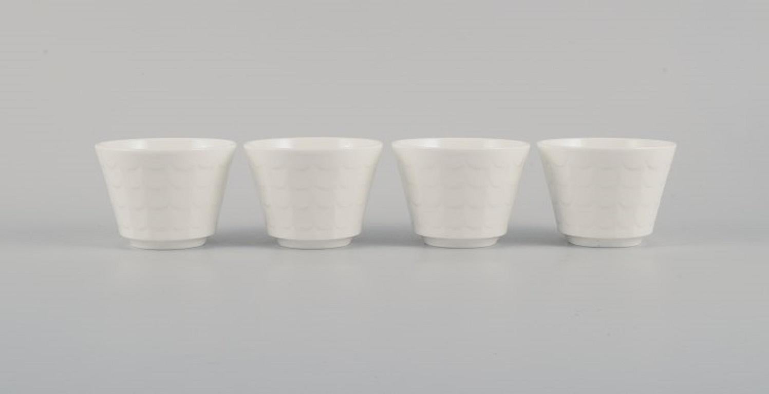 Wilhelm Kåge for Gustavsberg. Four flower pot covers in porcelain. 
Swedish design, 1960s.
Measures: 8.0 x 6.0 cm.
In excellent condition.
Marked.