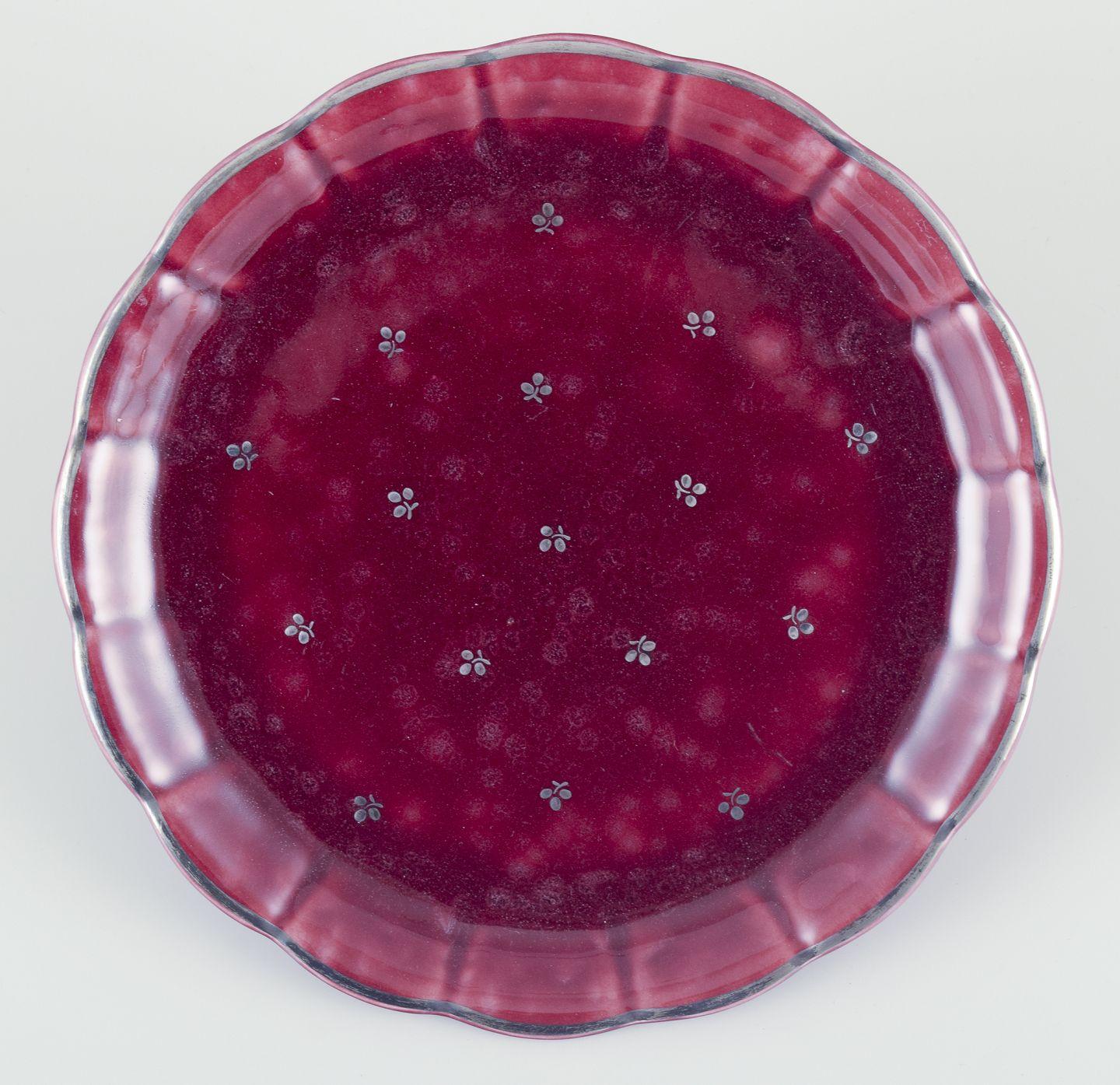 PRE-OWNED GOODS ARE EXEMPT FROM IMPORT TARIFFS FOR U.S., UK, AUSTRALIAN & CANADIAN CUSTOMERS.   
THEREFORE, NO IMPORT TARIFFS WILL BE APPLICABLE TO YOUR PURCHASE. 

Wilhelm Kåge for Gustavsberg.
A pair of “Argenta” ceramic dishes.
Rare bordeaux