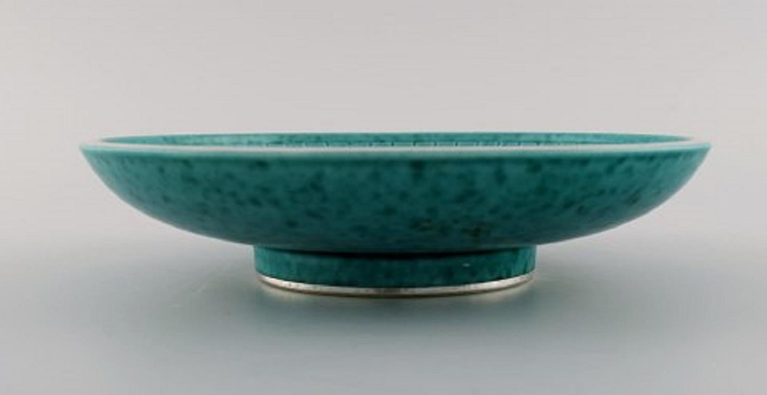 Wilhelm Kåge for Gustavsberg. Rare Argenta Art Deco bowl in glazed ceramics decorated with fish in the silver inlay, Sweden, 1940s.
Measures: 18.5 x 4 cm.
Stamped Gustavsberg, Kåge.
In perfect condition.