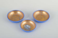 Wilhelm Kåge for Gustavsberg. Set of 3 faience bowls with blue and gold glaze.