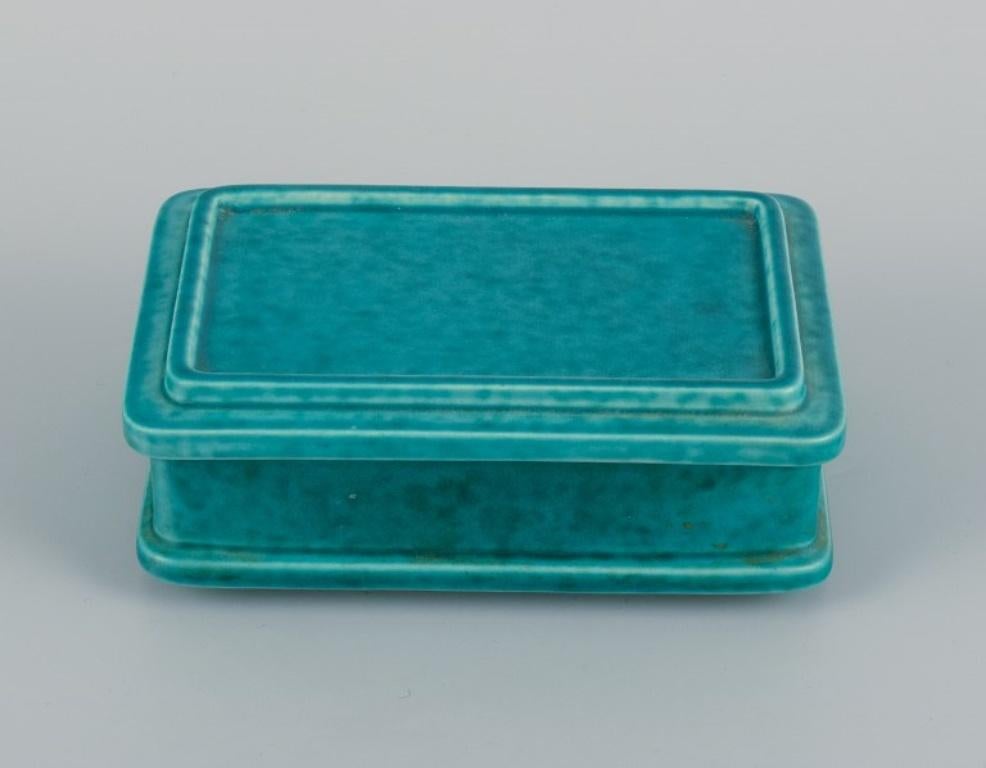 Wilhelm Kåge for Gustavsberg, Sweden. Argenta container with lid in ceramic.
1940s.
In perfect condition.
Unstamped.
Dimensions: L 14.5 x D 10.0 x H 5.5 cm.