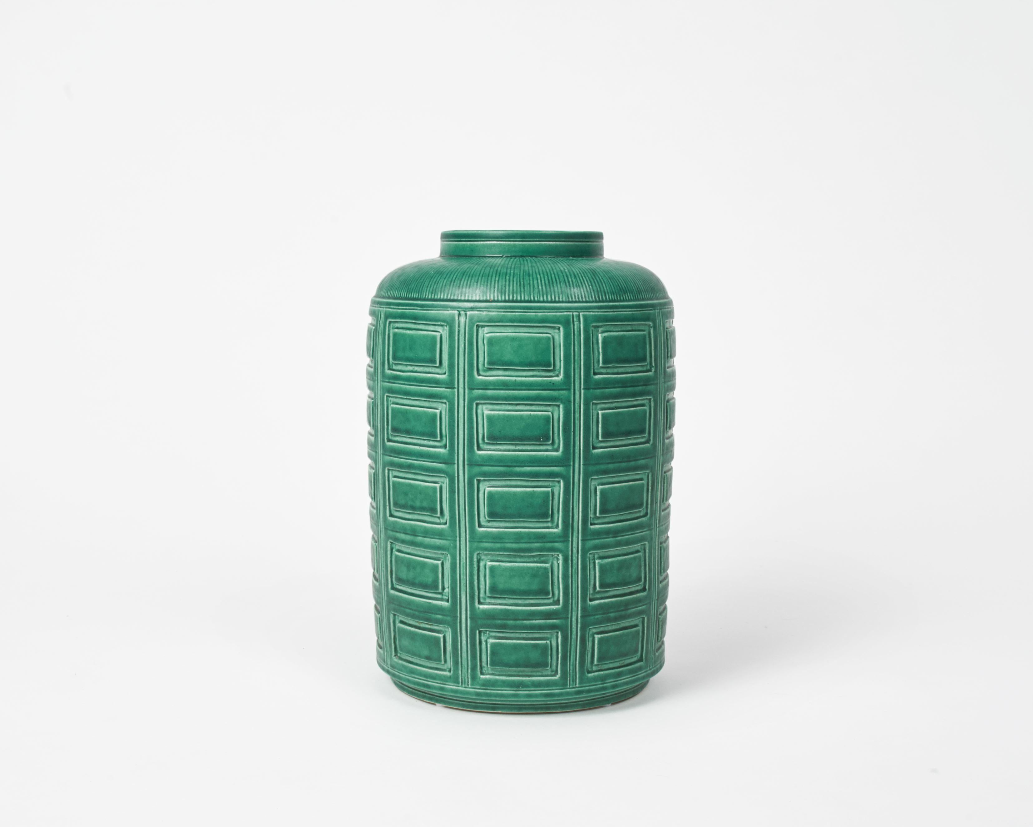 This beautiful piece is part of the artist's Argenta Series, which he produced for the Gustavsberg Factory, and which first won him major success. The series includes everything from ashtrays to 60 kg urns-- primarily in a green glaze with silver