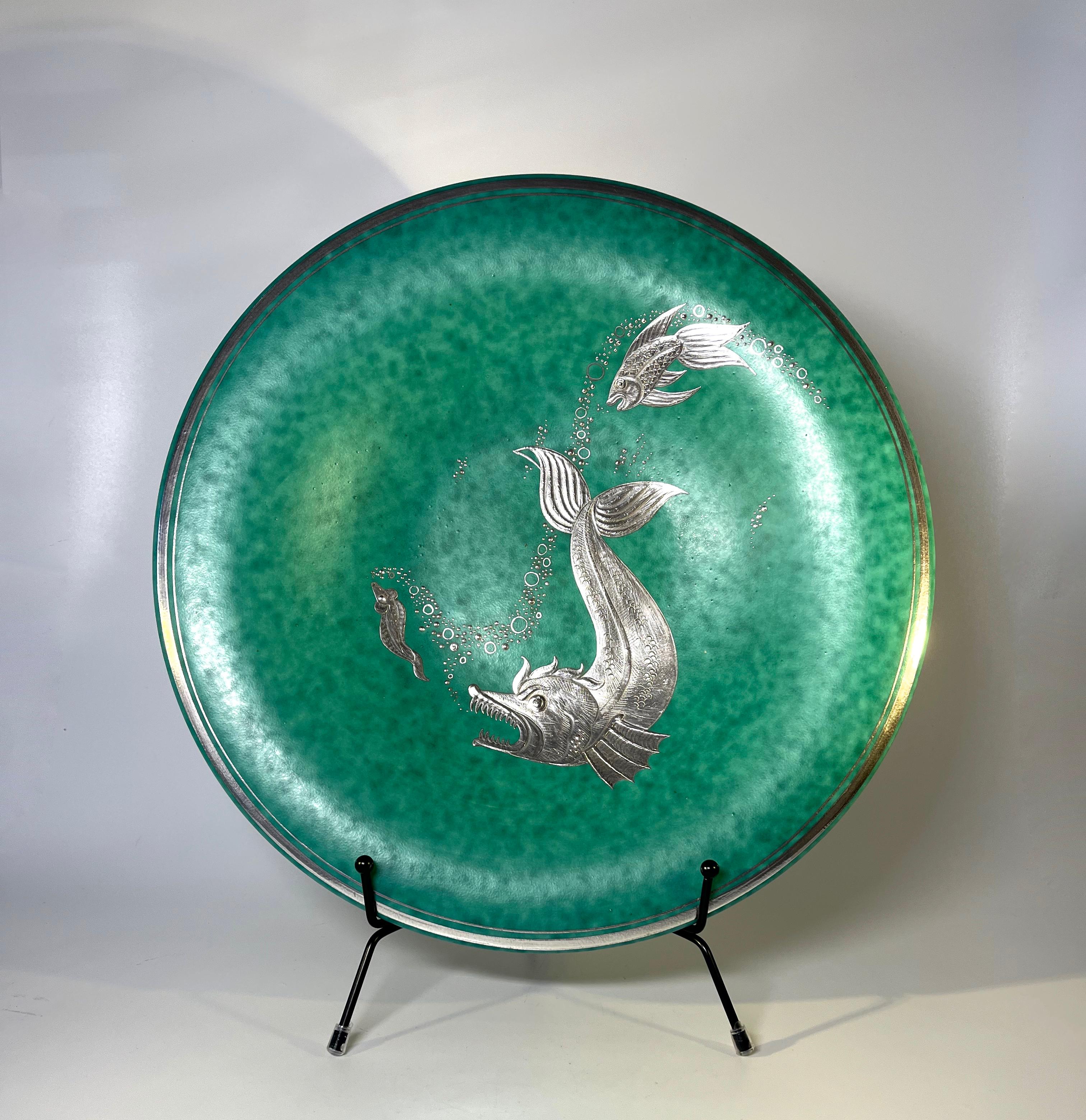 Superb stoneware Argenta centrepiece by Wilhelm Kage for Gustavsberg, Sweden
An applied silver animated aquatic scenario furnishes the plate
Outer rim has a double applied silver banding 
Circa 1950's
Signed to base Argenta 1035 I 
Measures: