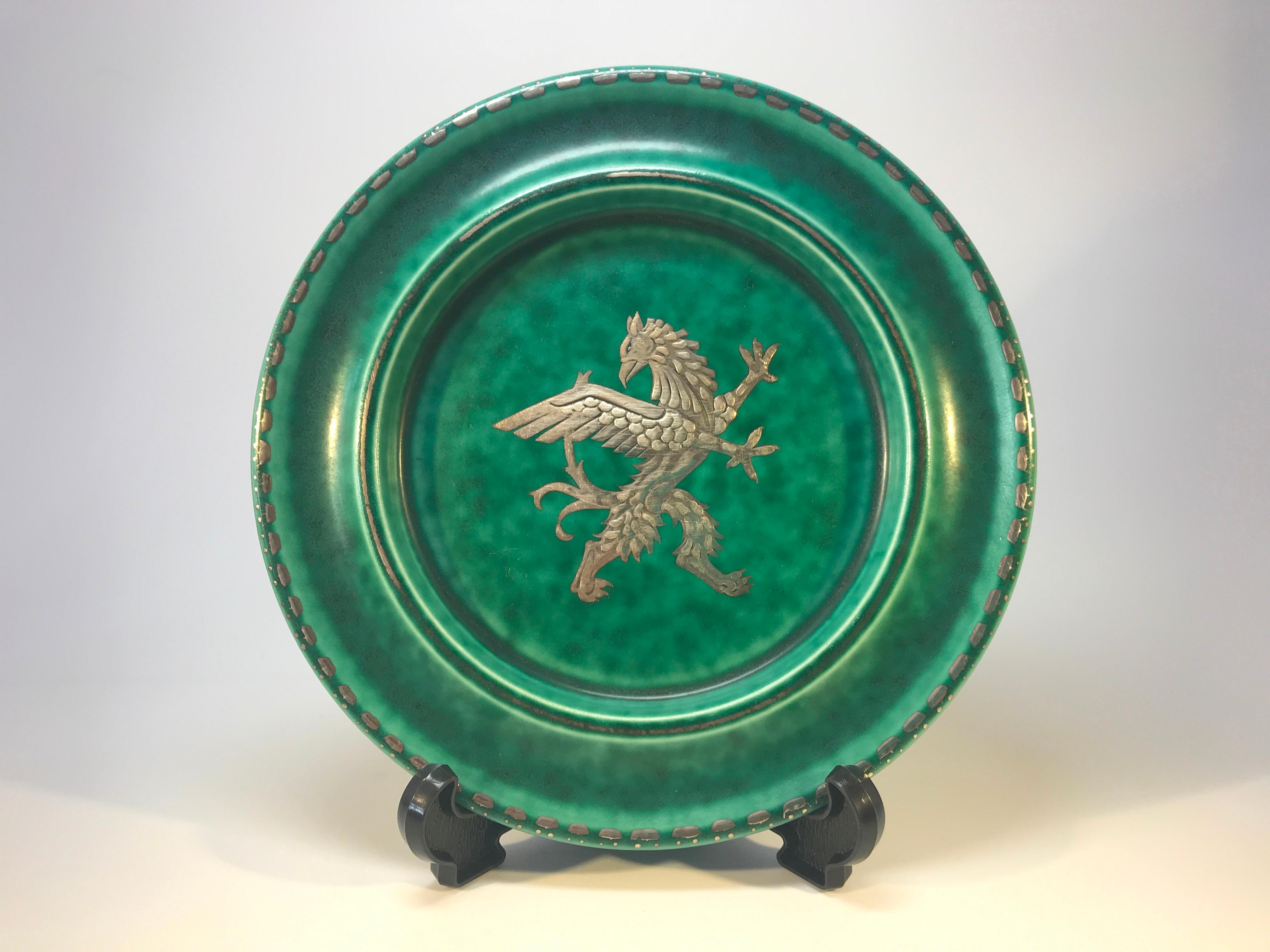 Decorative and vibrant green raised plate with applied silver decoration of a winged griffon by Wilhelm Kage for Gustavsberg, Sweden, circa 1930s
Stamped Argenta on reverse
Good condition. Some wear to the silver of inner rim.