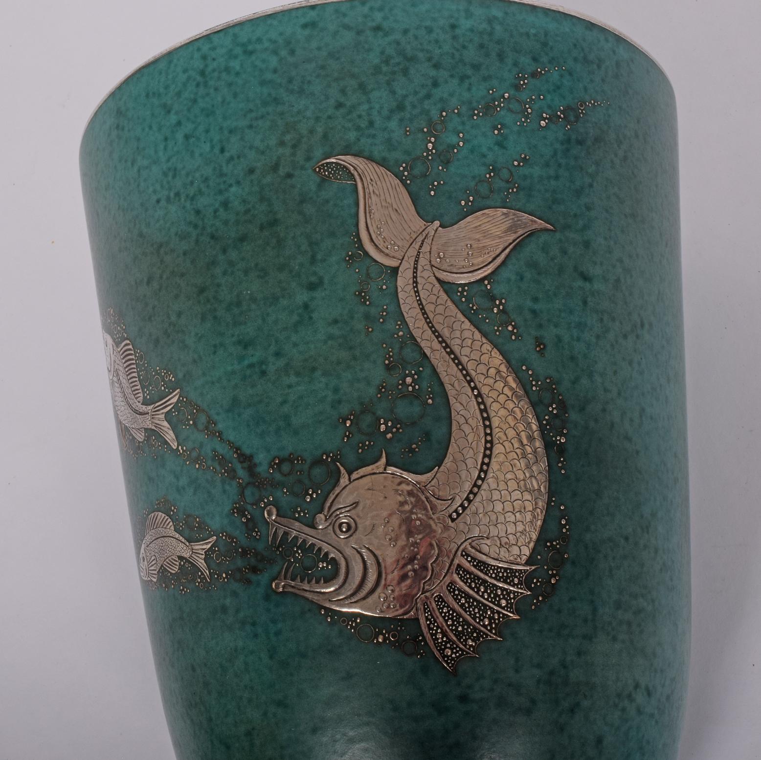 Large Argenta vase with fish, Glazed stoneware, silver inlay; Manufacturer stamp/HANDDREJAD, inlaid signature GUSTAVSBERG D ARGENTA with anchor/978/IV/E MADE IN SWEDEN. 11 1/2