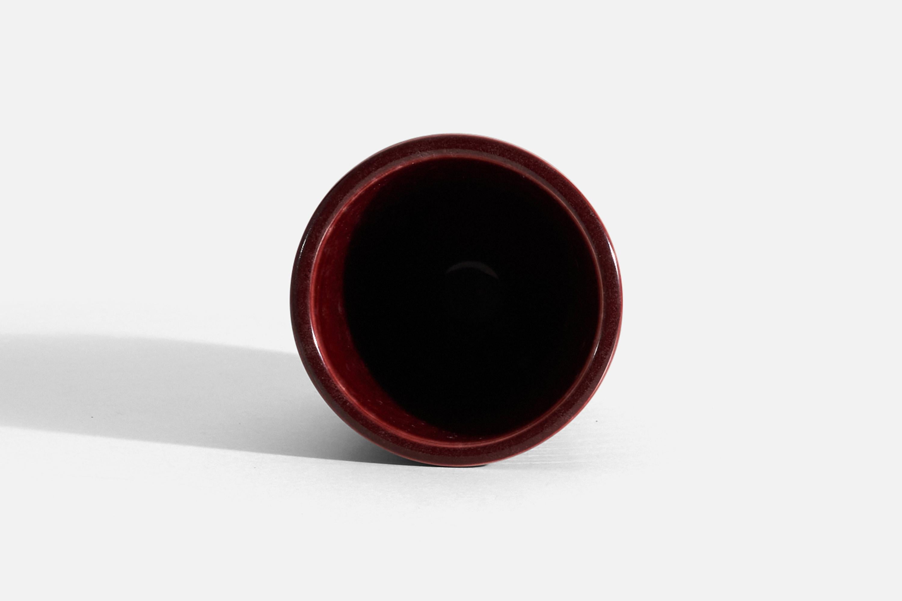 A red / oxblood incised vase designed by Wilhelm Kåge and produced by Gustavsberg, Sweden, c. 1950s.

 