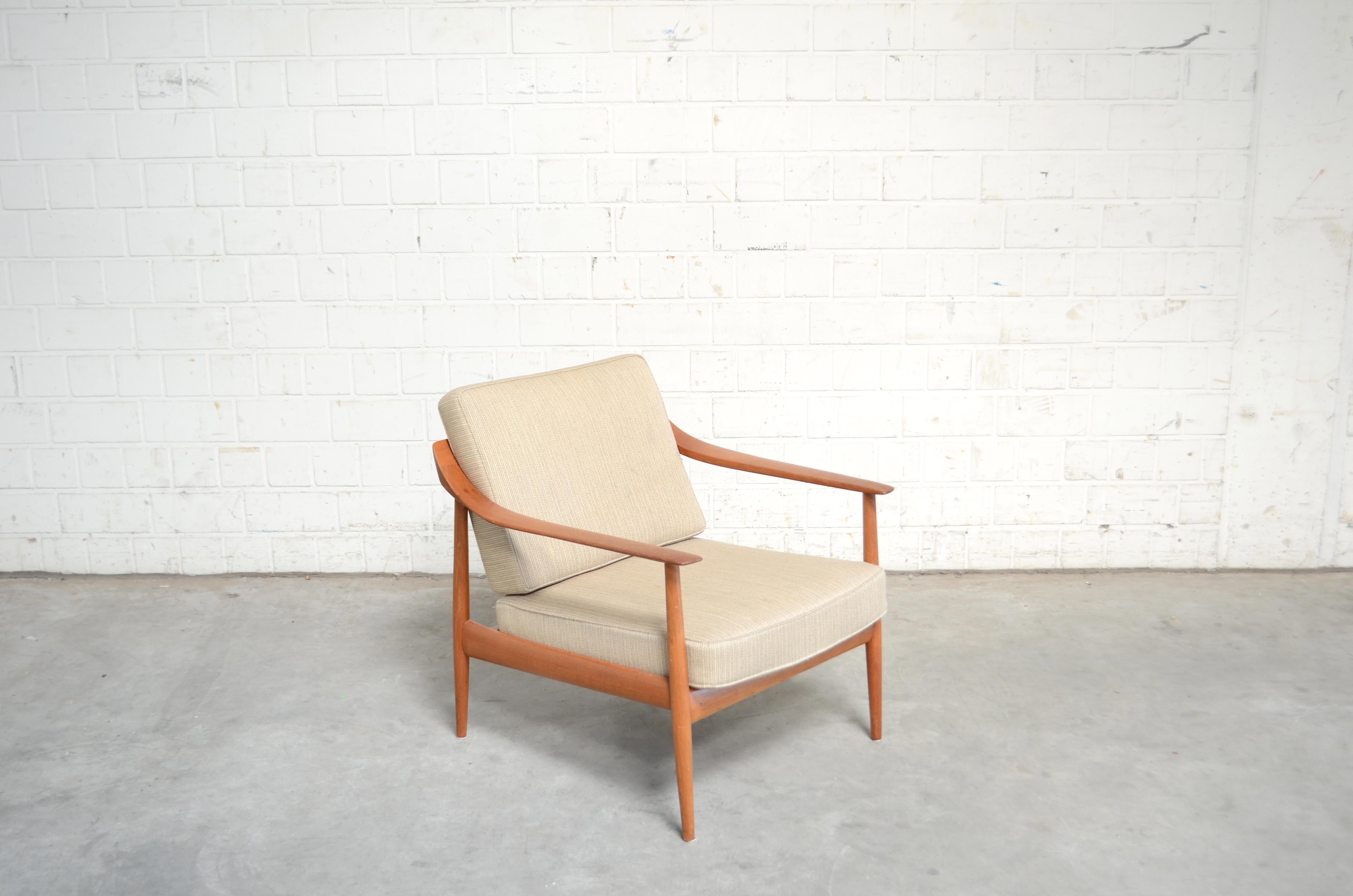 Wilhelm Knoll manufactures this armchair
From the Series Antimott.
The frame is made of oiled teak.
Wool fabric is original and has a little stain.
 