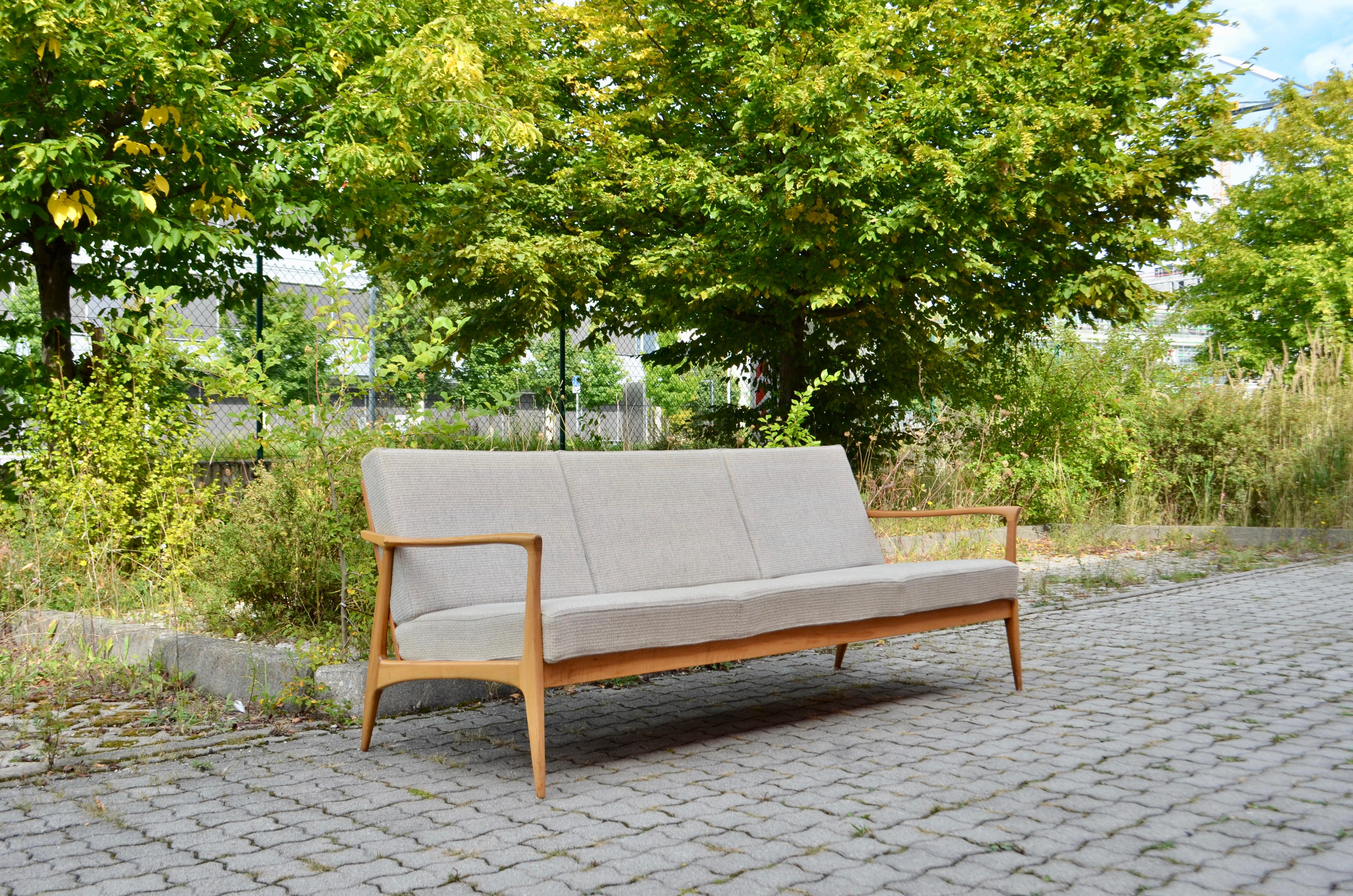 Wilhelm Knoll manufactures this nice sofa. 
From the Series Antimott.
The armrests are beautiful curved and have a sculptural line.
Frame is made of lacquered walnut
The original Fabric is a light grey wool.
 